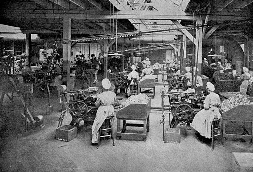 Factory setting from 1909: workers spinning thread in a textile mill
