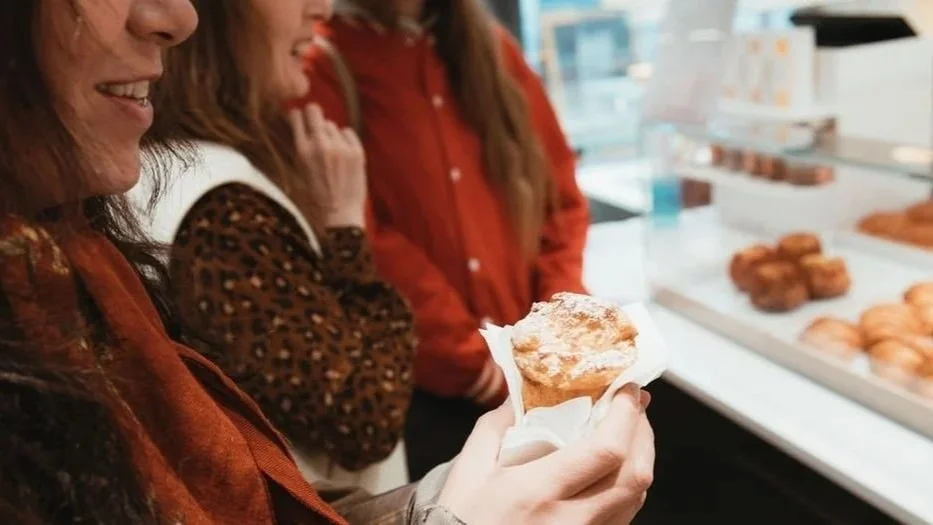 woman eating a pastry on a Paris Food Tour