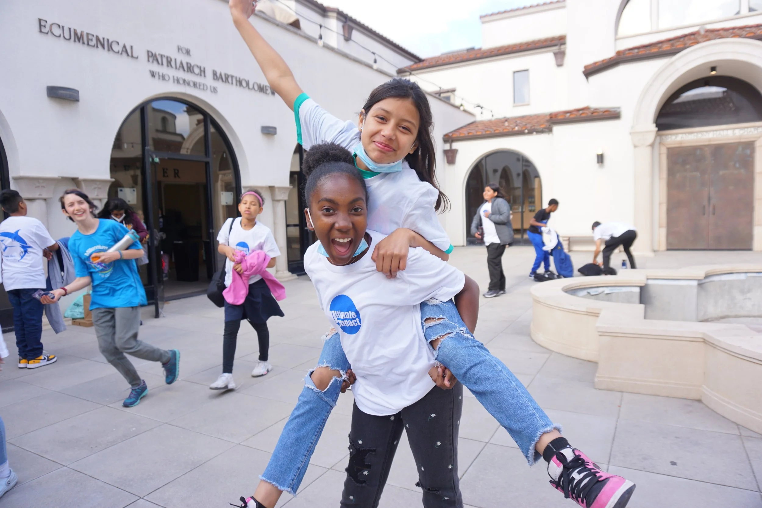 two girls wearing ultimate impact shirts
