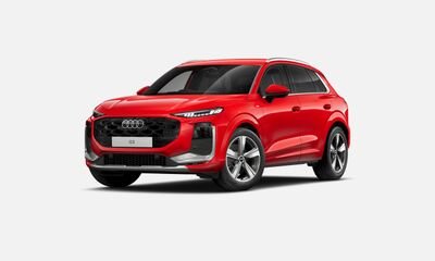 Red Audi SUV against a plain gray background.