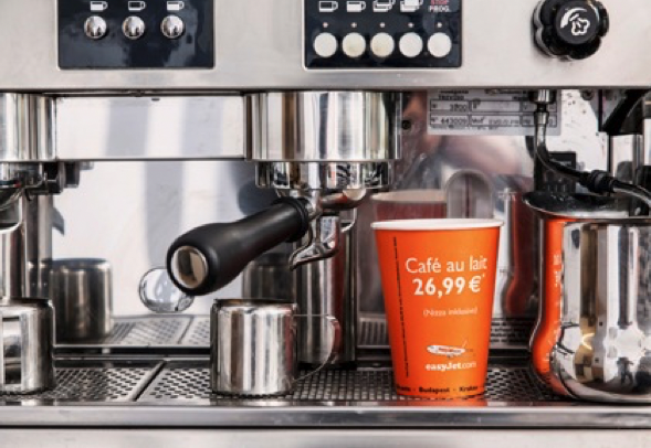 A close-up view of a professional espresso machine with an AD-cup