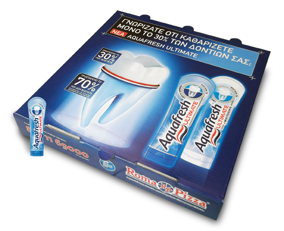 A box of Aquafresh Ultimate toothpaste with a toothbrush and toothpaste tube inside, placed on a surface with a Roma Pizza logo visible on the box.
