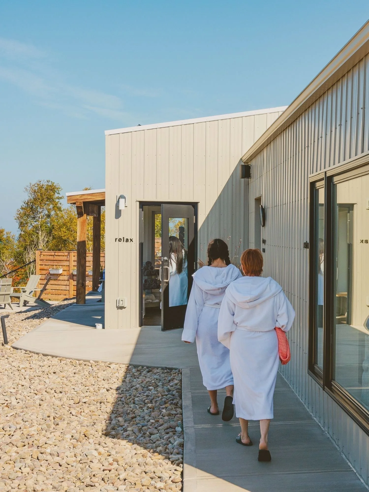 People in robes being led to the relax room after a Rise & Shine class for rest and balance