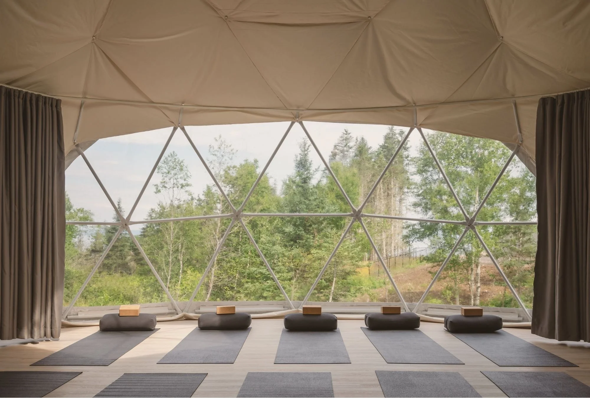 The Dome at Saltair is set up for Yoga, with mats and bolsters placed in front of the window.