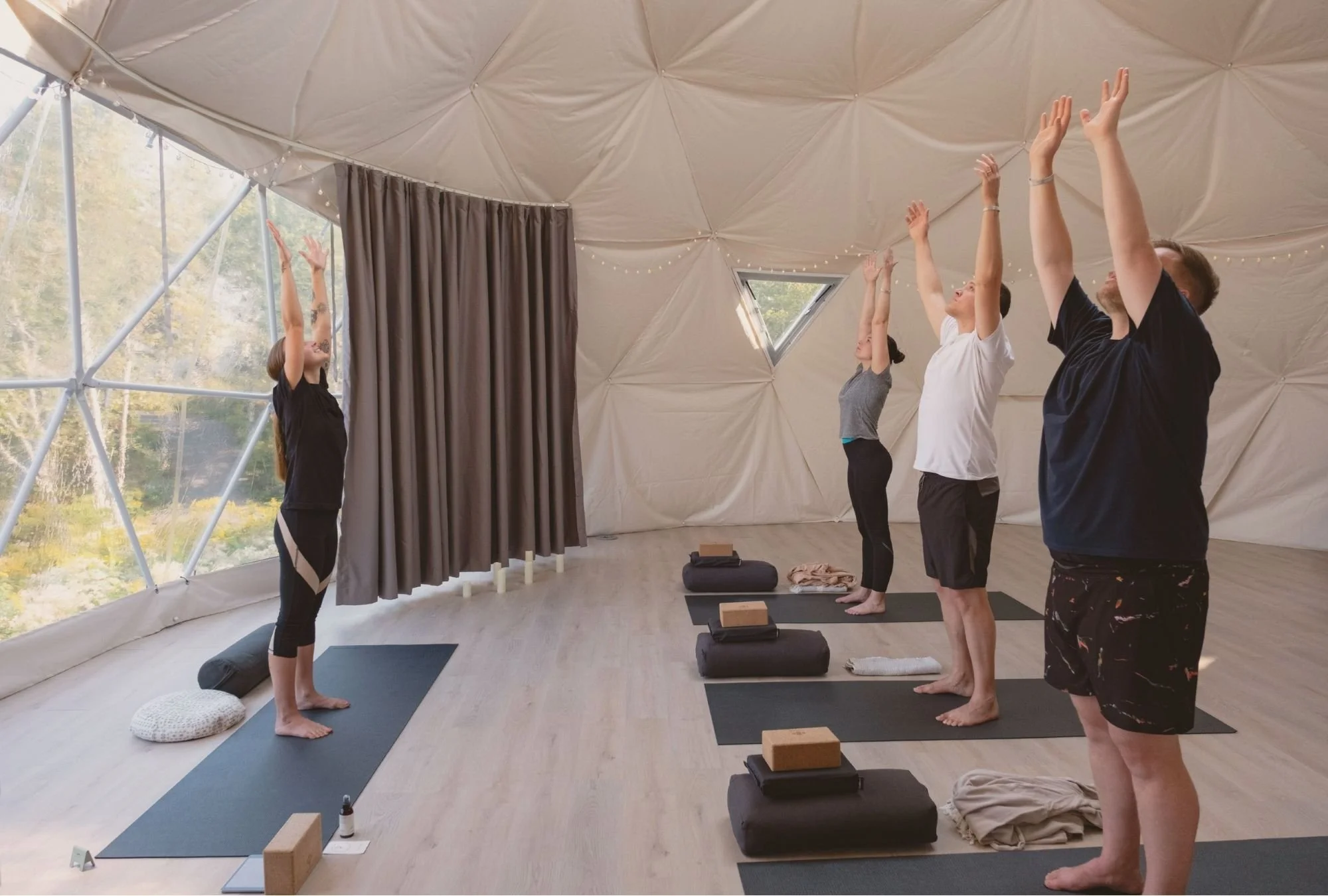People being led through a Rise & Shine Guided Yoga class in the Dome at Saltair