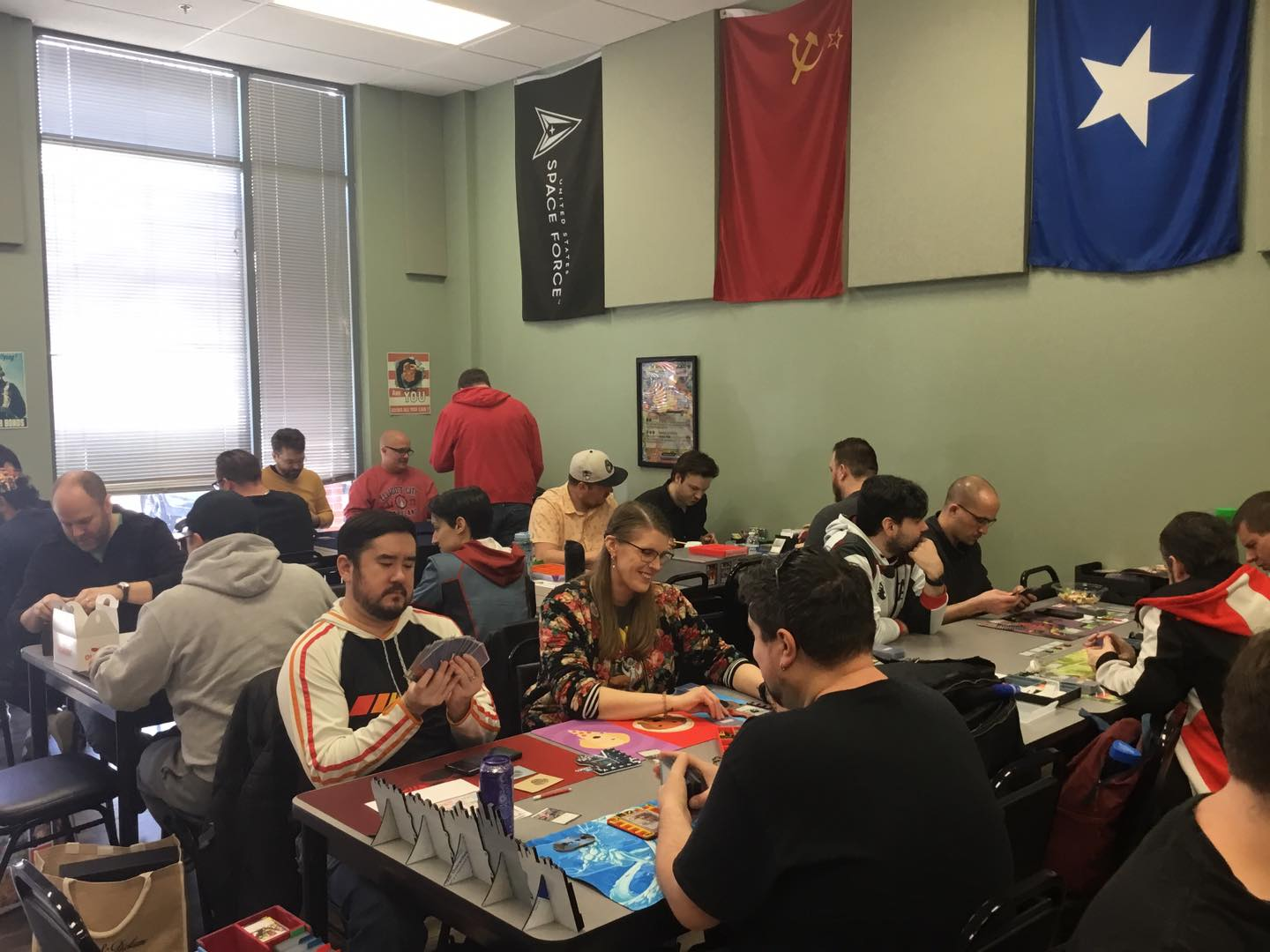 A group of people playing Marvel Champions Living Card Game at Huzzah Hobbies.