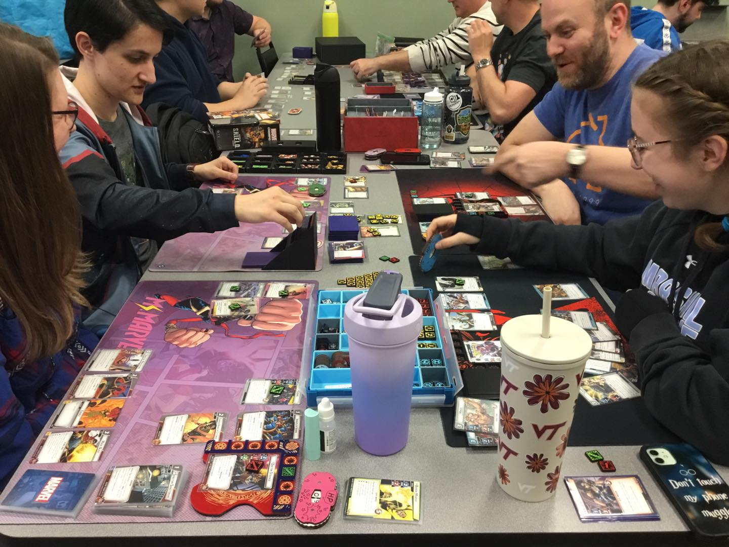 A group of people playing Marvel Champions Living Card Game at Huzzah Hobbies.