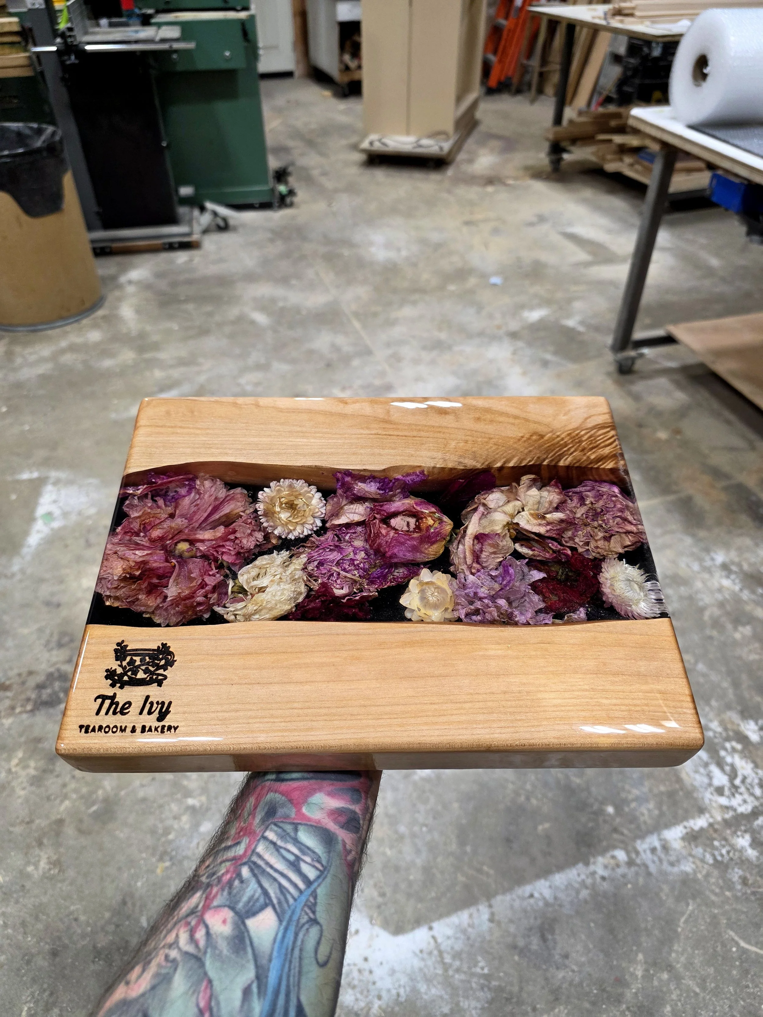 personalized resin charcuterie board with dried flowers and epoxy resin and live edge maple