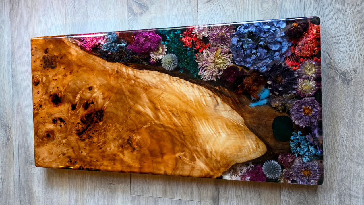 Large charcuterie board made from mixed dried flowers in a floral arrangement with burl wood and epoxy resin