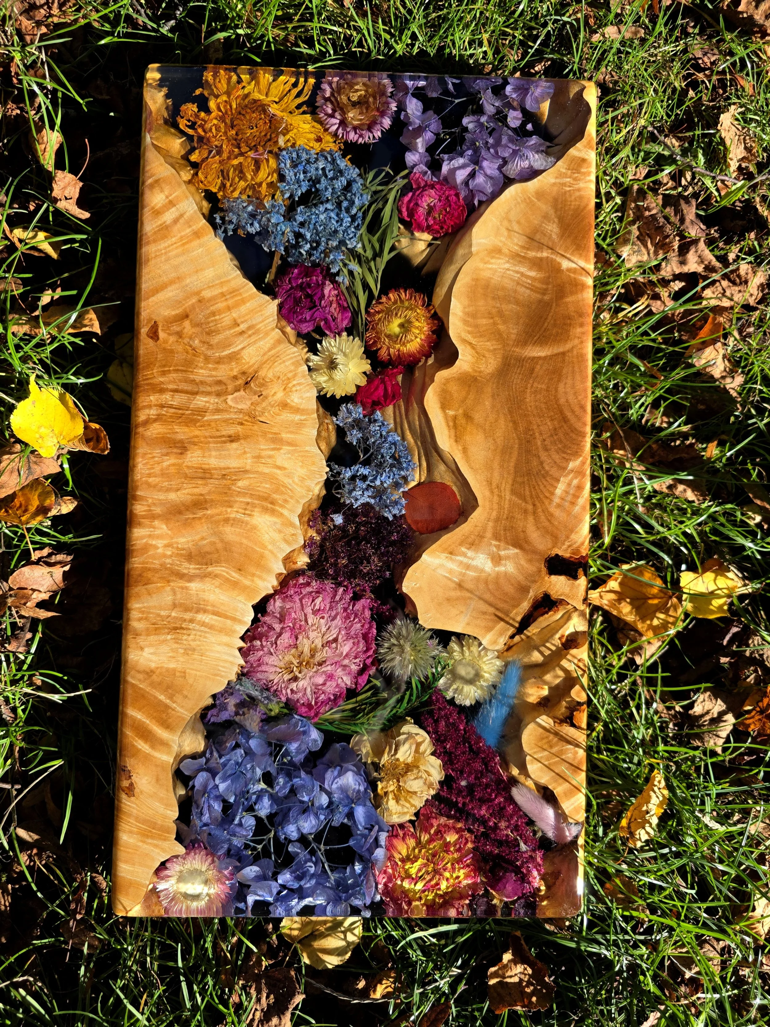 Resin charcuterie board - live edge maple burl wood and bright flowers in epoxy resin