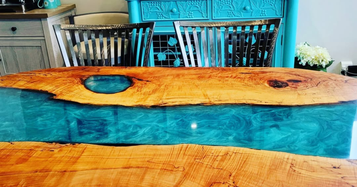 Custom wood dining table made with live edge spalted maple and bright blue epoxy dinner table