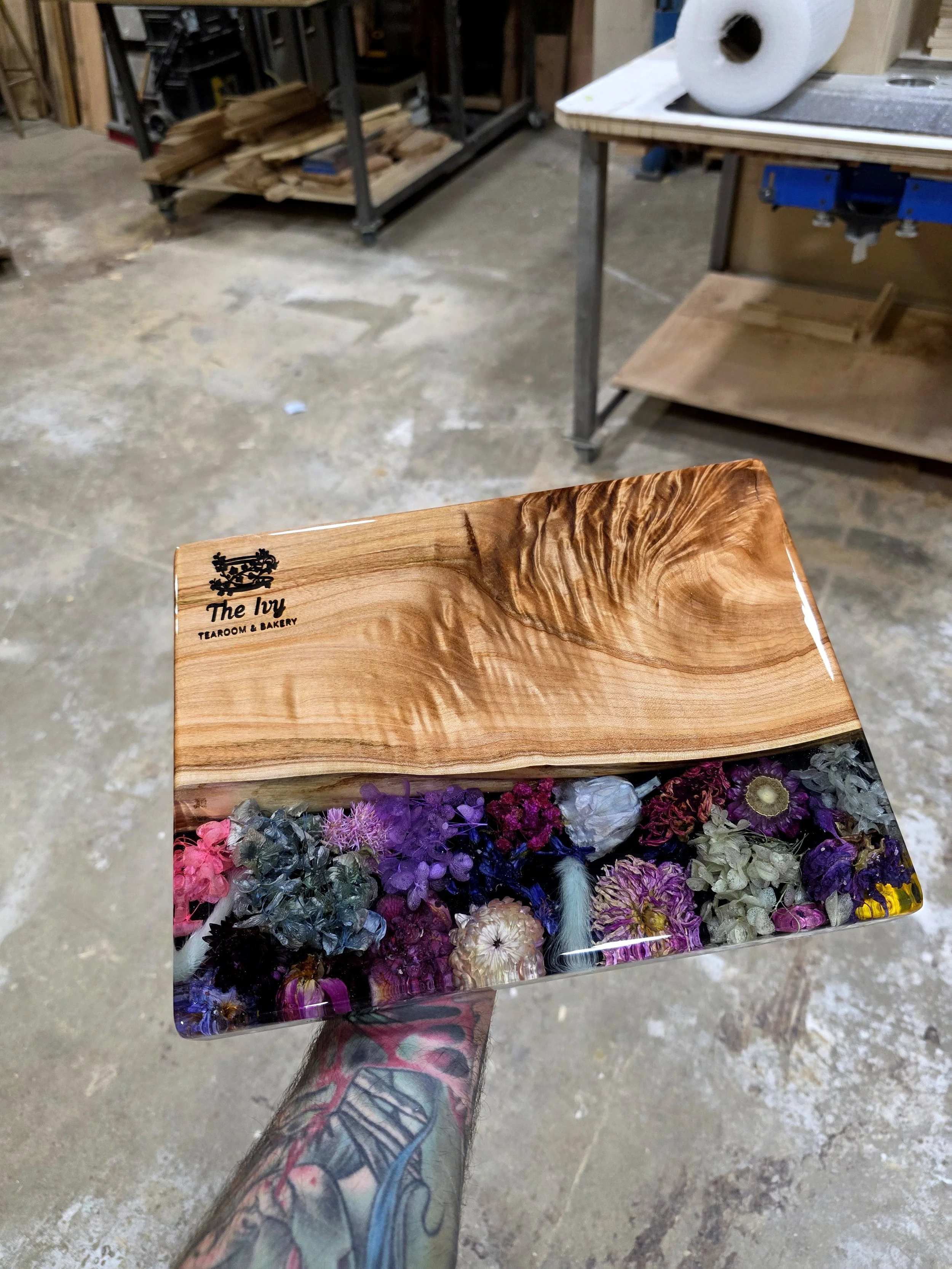 personalized resin charcuterie board with preserved flowers and figured maple live edge wood