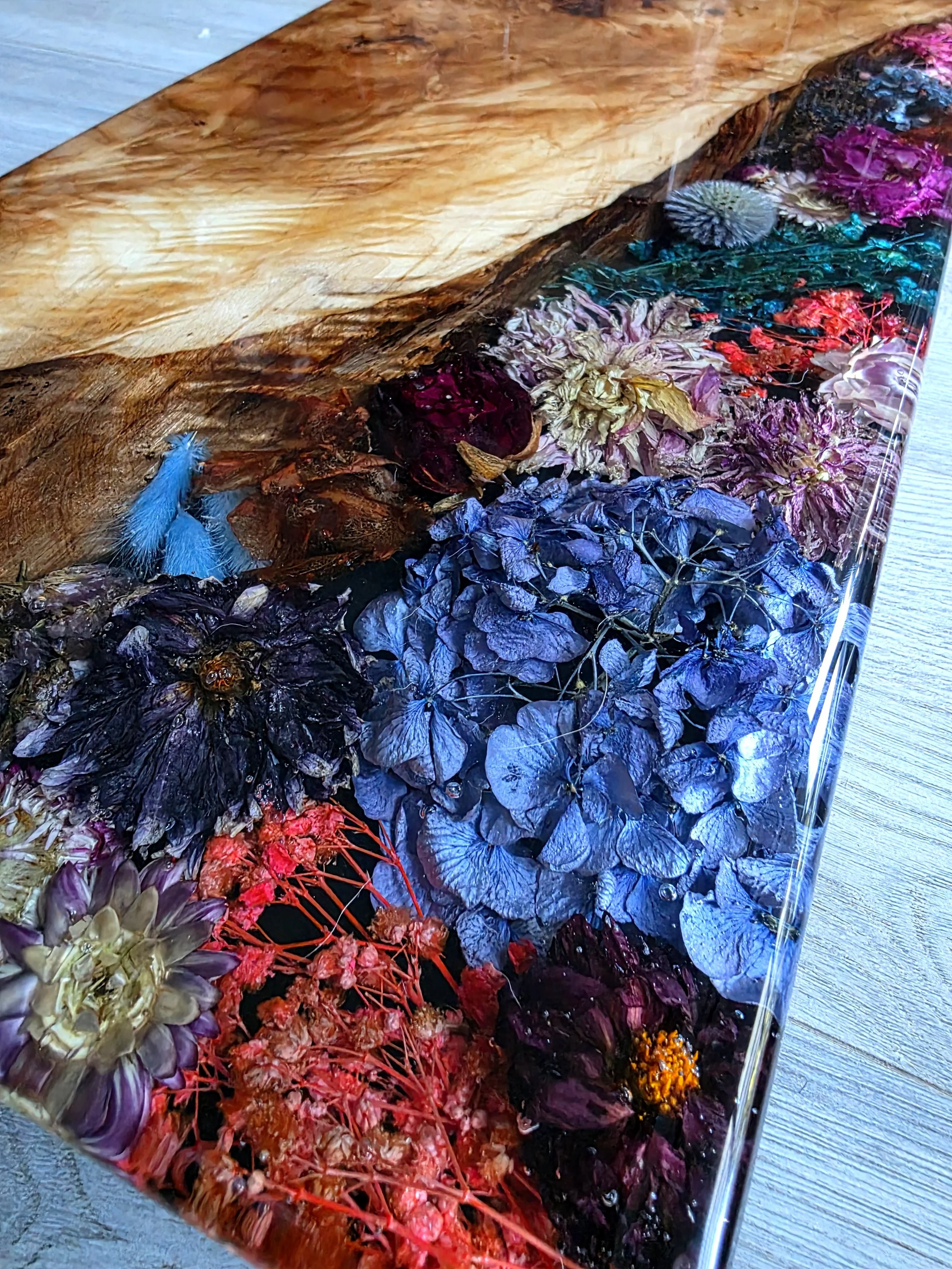 beautiful live edge wood with dried flowers and epoxy resin