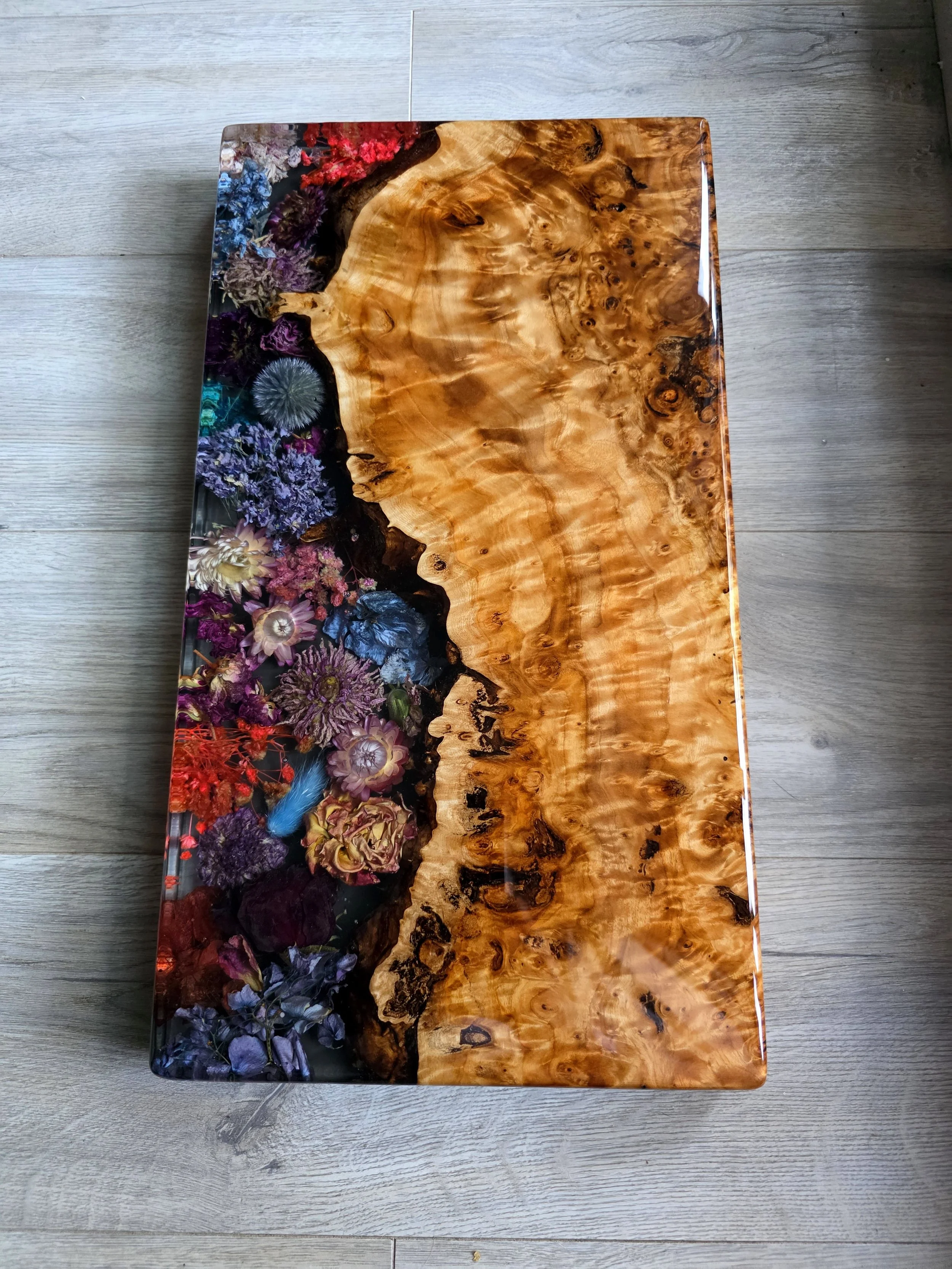epoxy charcuterie board - live edge wood burl wood and preserved florals encased in epoxy resin