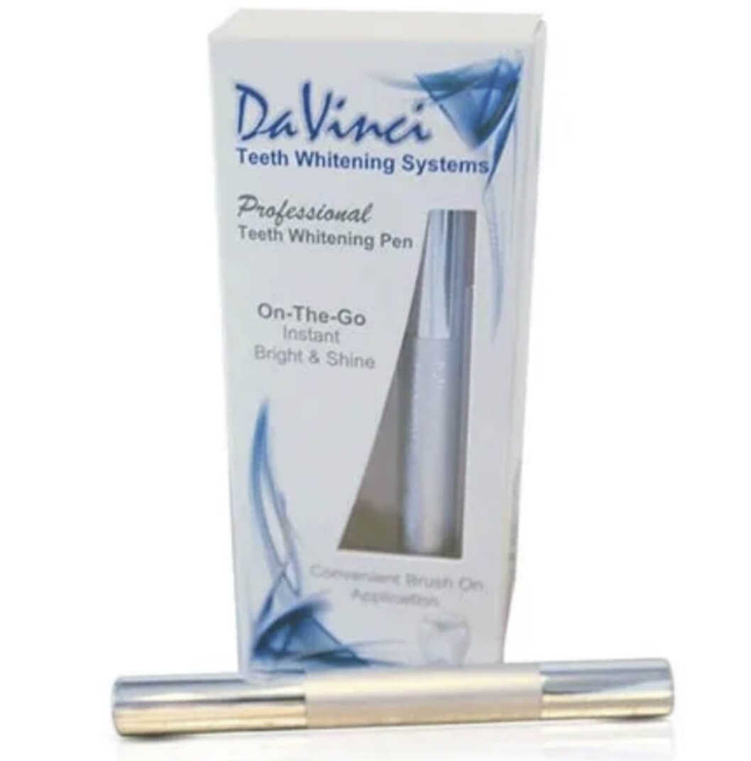 A teeth whitening pen beside its packaging box labeled 'DaVinci Teeth Whitening Systems' and indicating 'Professional Teeth Whitening Pen' with on-the-go, instant bright and shine benefits.