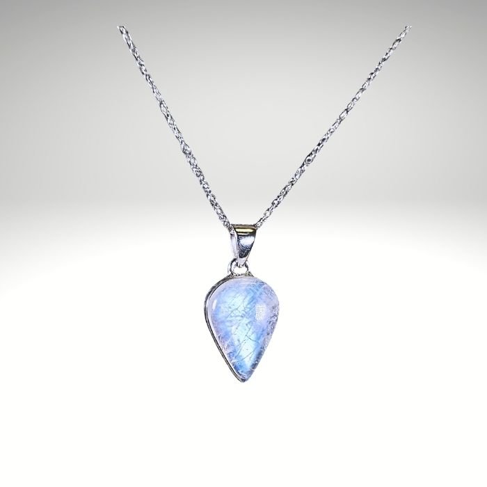 Rainbow Moonstone sterling silver pendant with bright blue flash, photographed at Infinity Energy Spa & Crystal Shop.
