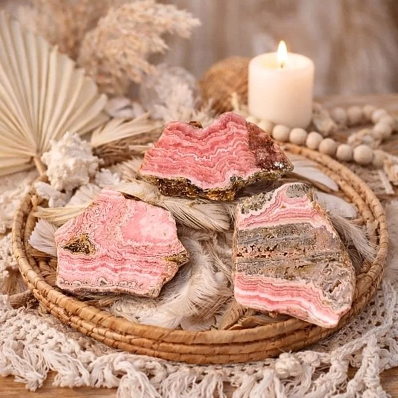 Rhodochrosite slab with pink and white banding, polished and displayed at Infinity Energy Spa & Crystal Shop.