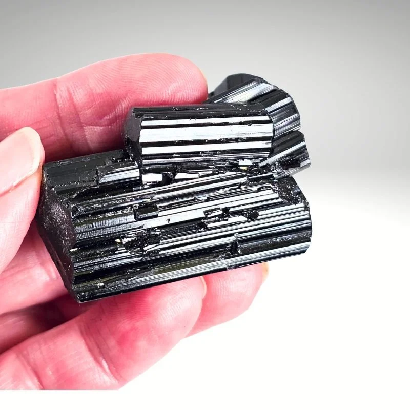 Black Tourmaline (Schorl) crystal from Madagascar at Infinity Crystal Shop, known for grounding and protective energy.