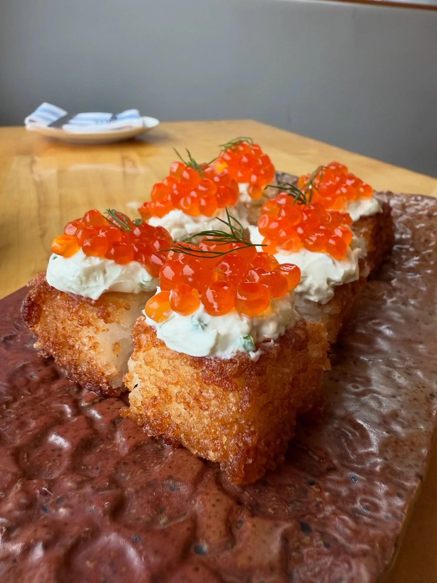 Golden Crispy Sushi Rice - topped with Alaskan salmon roe and wasabi scallion cream cheese