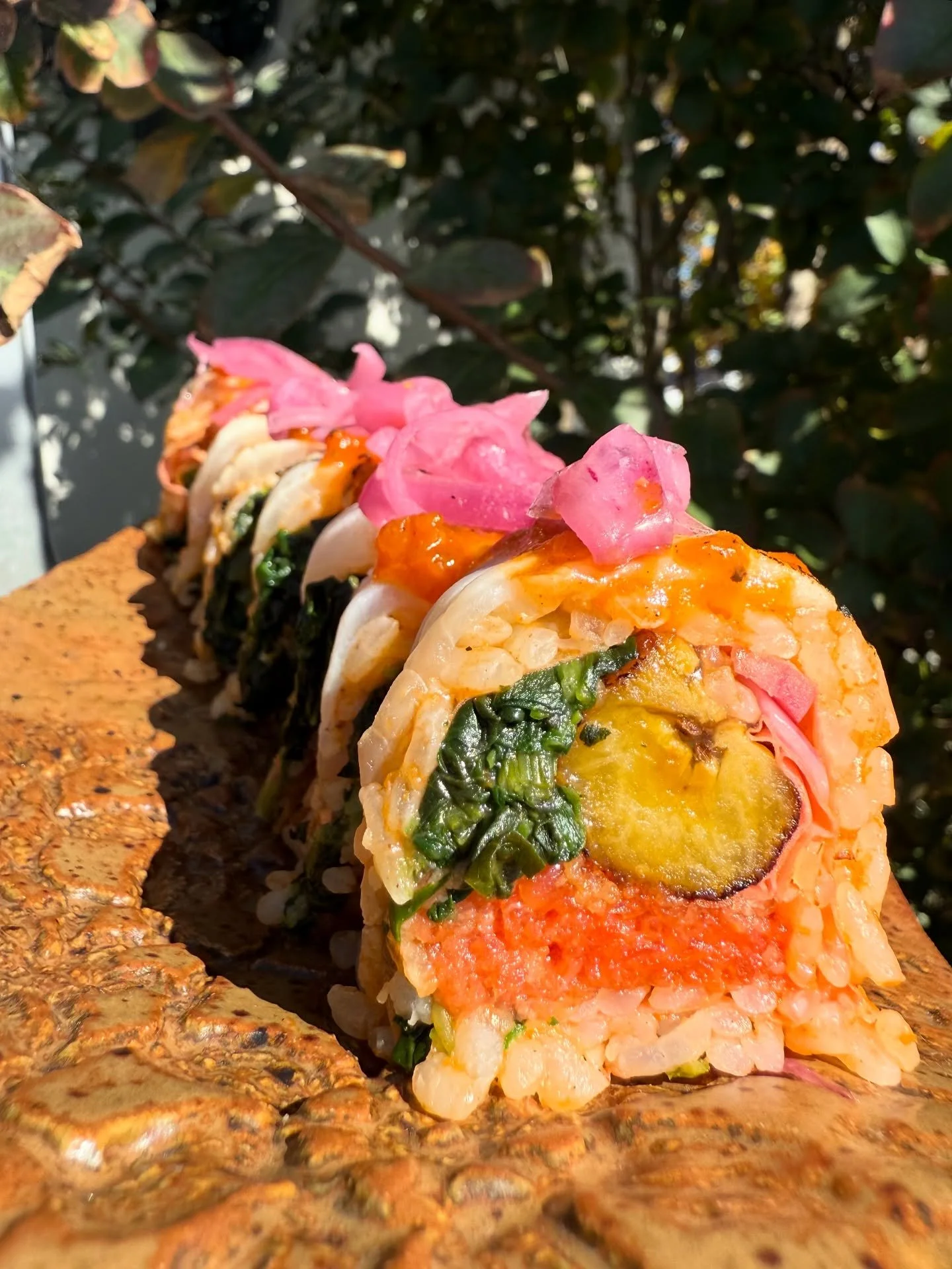 Jollof Roll - slow cooked tomato rice, spicy tuna, stewed spinach, sweet plantain; red snapper sashimi, pepper sauce, pickled red onions