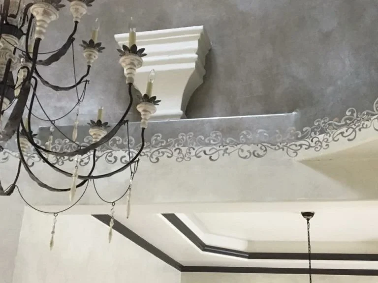 Hand painting connecting metallic ceiling dome and lime paint walls