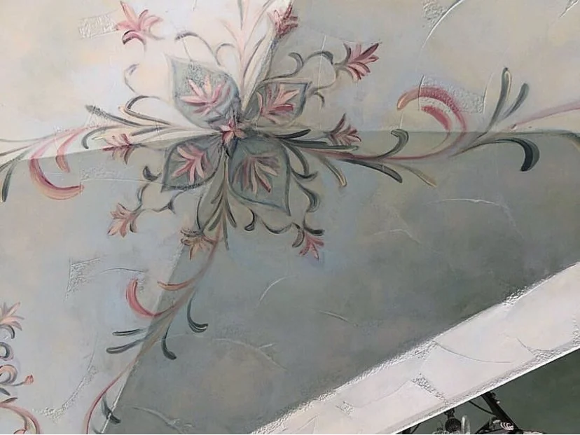 Blue finish on walls with hand painting on it throughout hallway