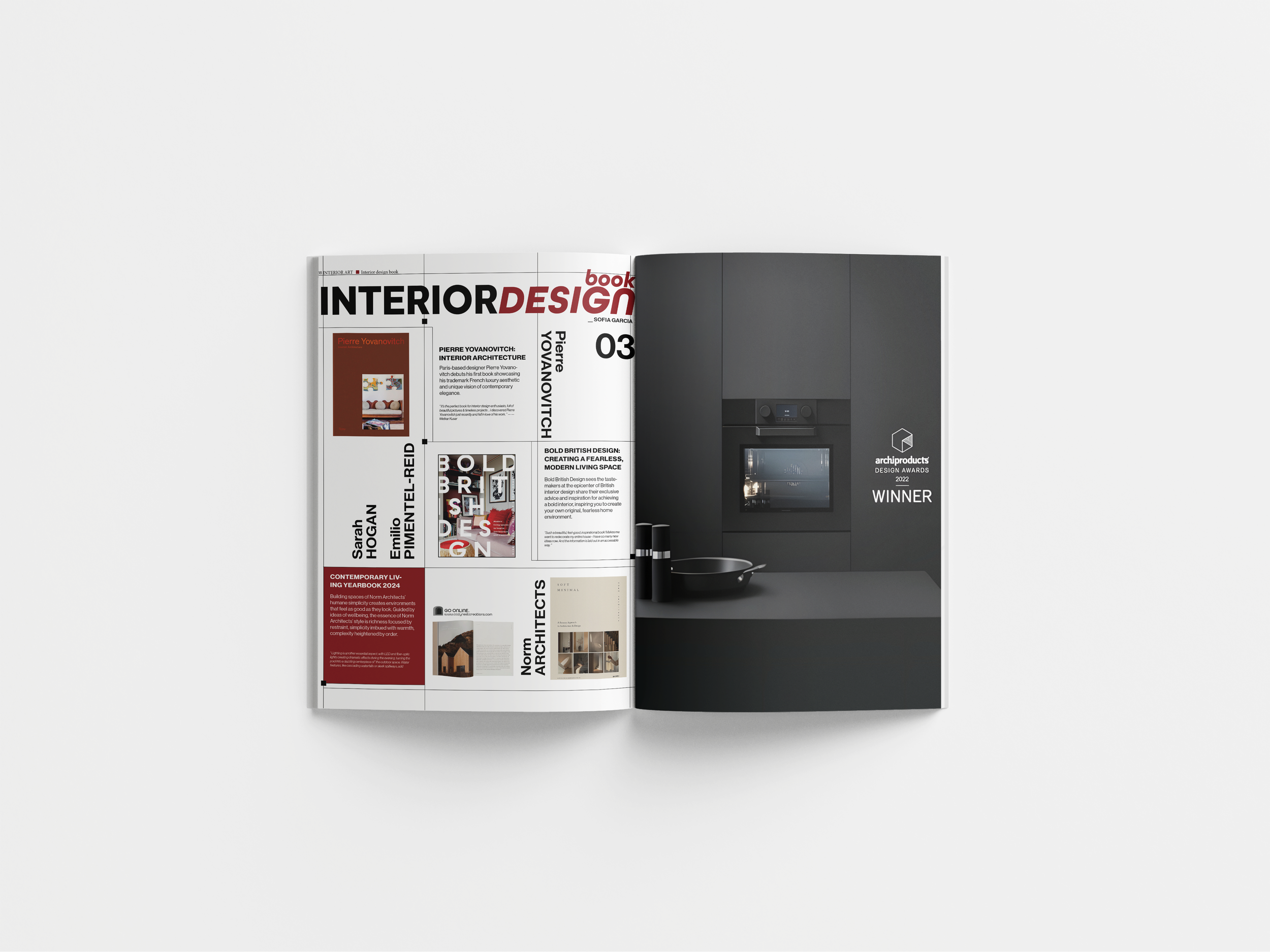 Open magazine showcasing interior design featuring a kitchen with black appliances and a ''winner'' label on the right page.