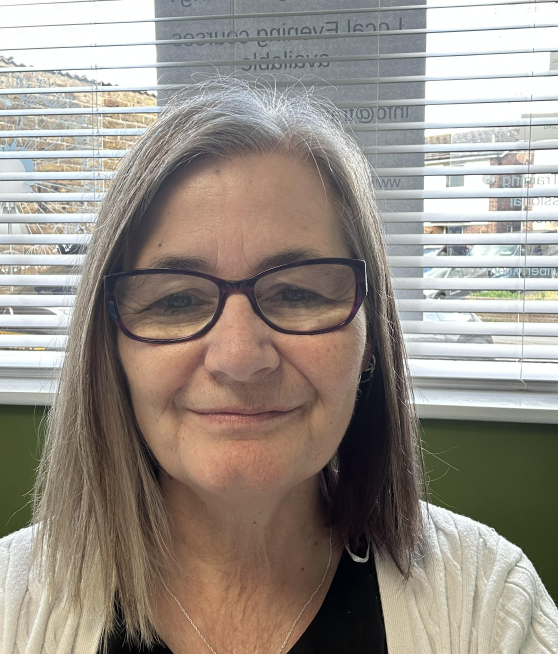 Image of woman in glasses smiling with a bob hair