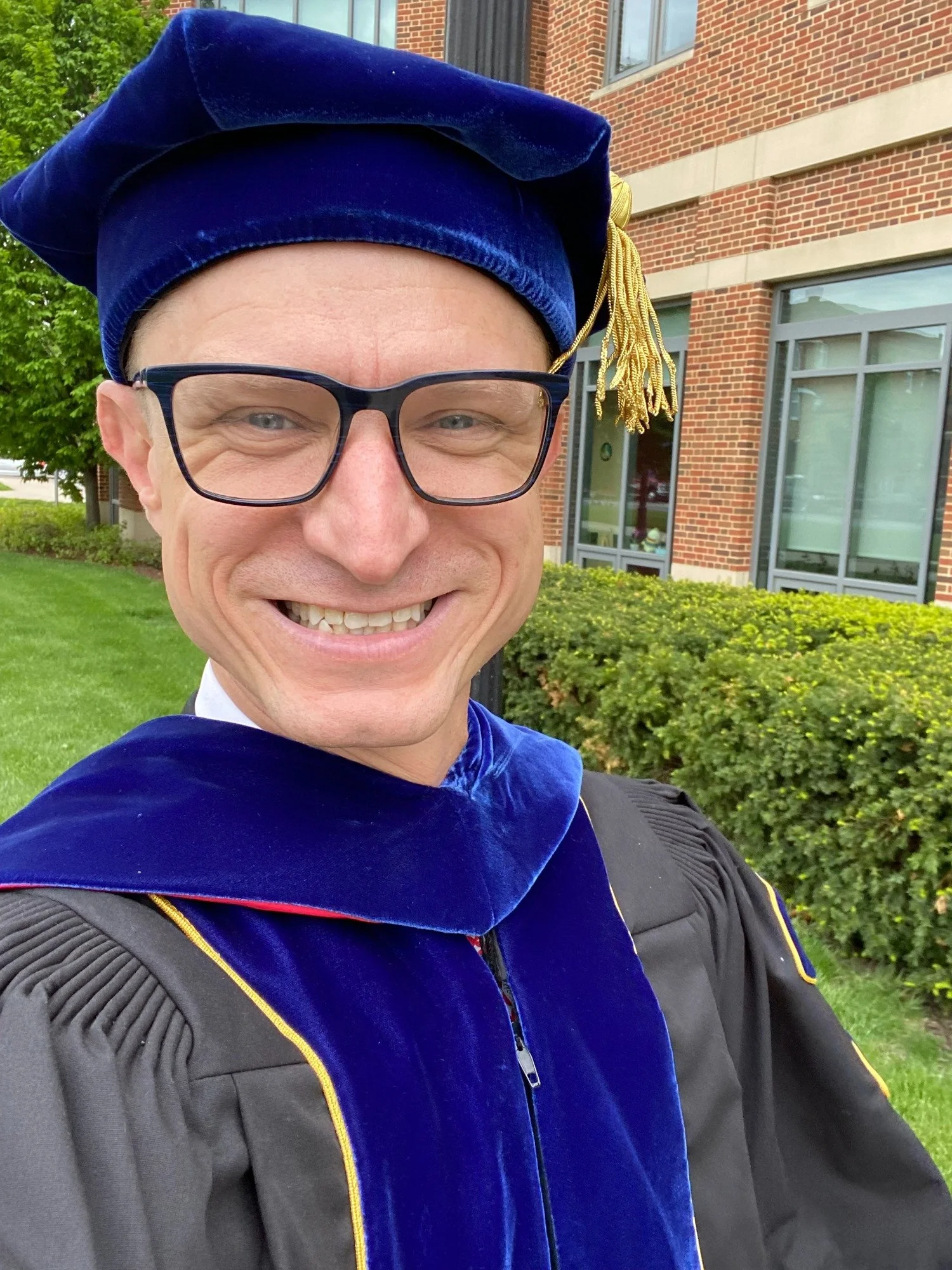 Dr. Danny Glassmann in doctoral academic regalia