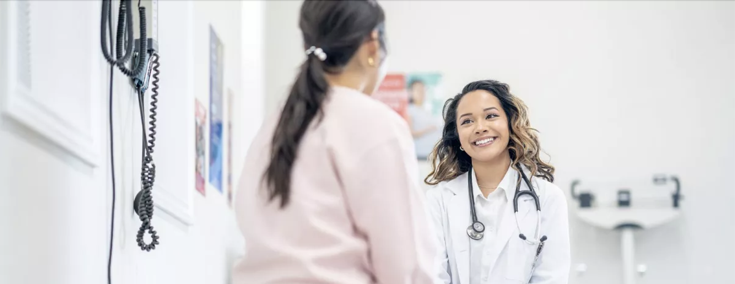 A woman with her doctor in the doctor's office.