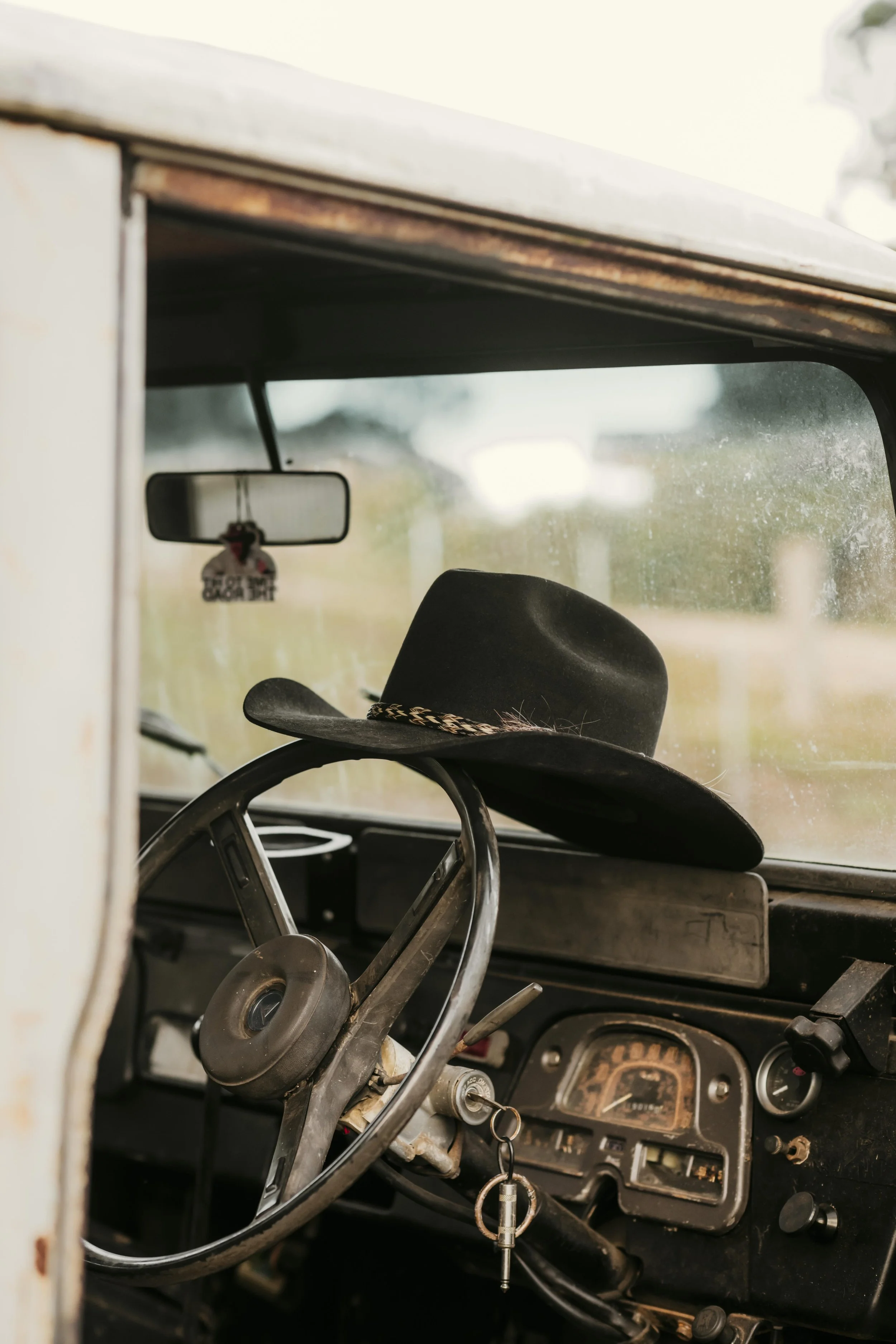 Cowboy hat inside a vintage LandCruiser on a rustic Australian farm