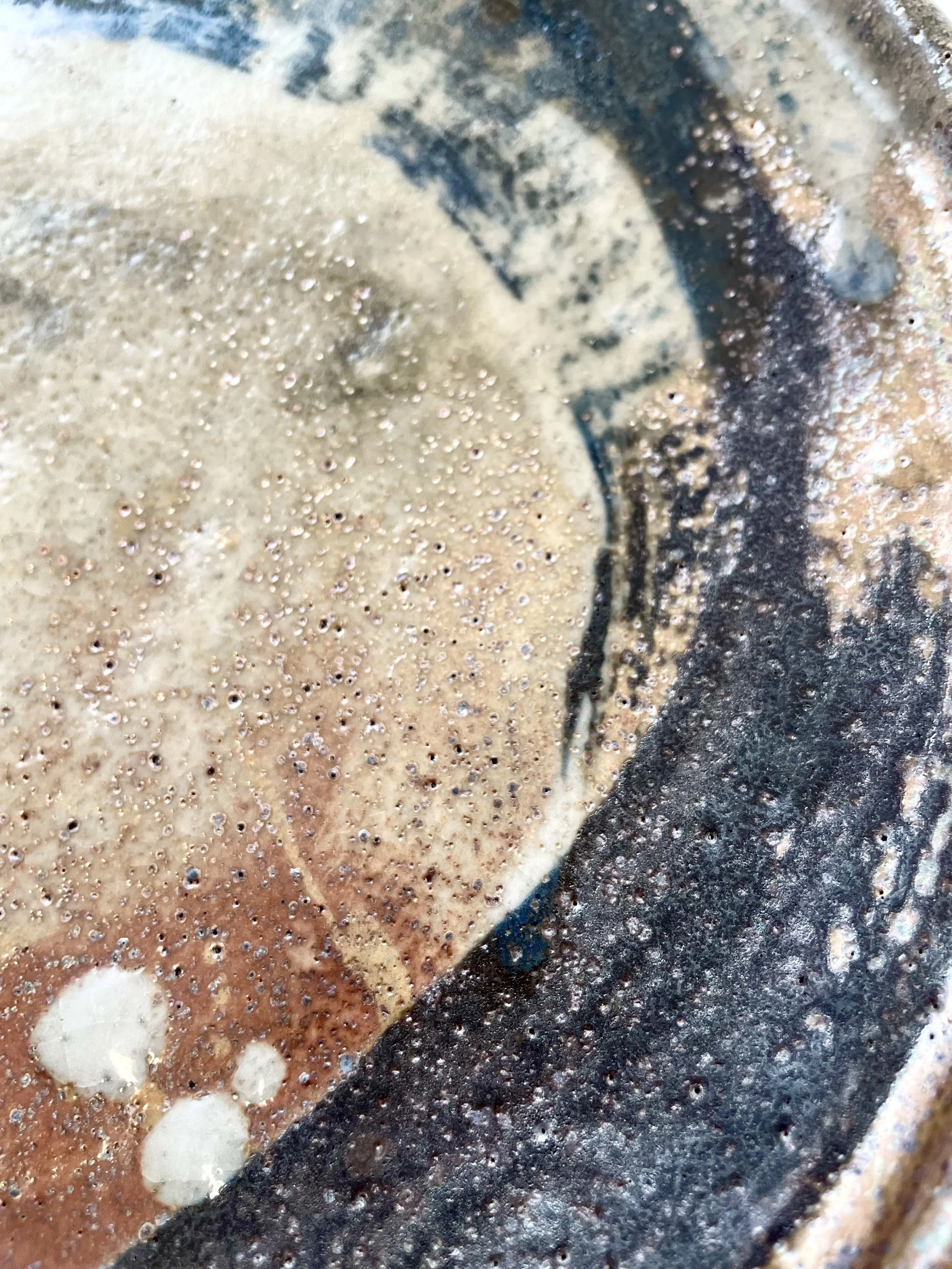 Close-up of glazes on a plate. Reduction fired.