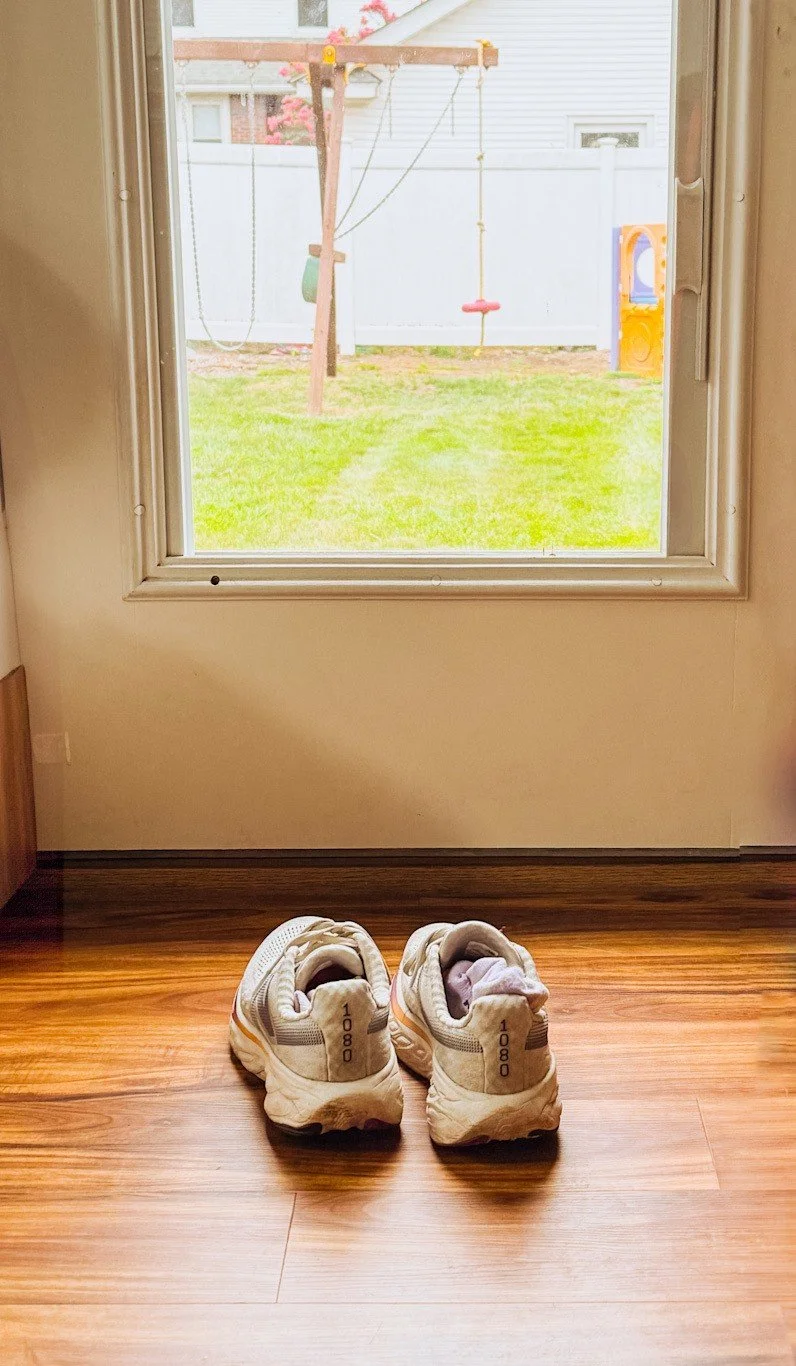 walking shoes by glass door