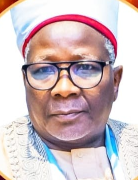 Close-up of a man wearing glasses, a white and red traditional cap, and a white traditional outfit.