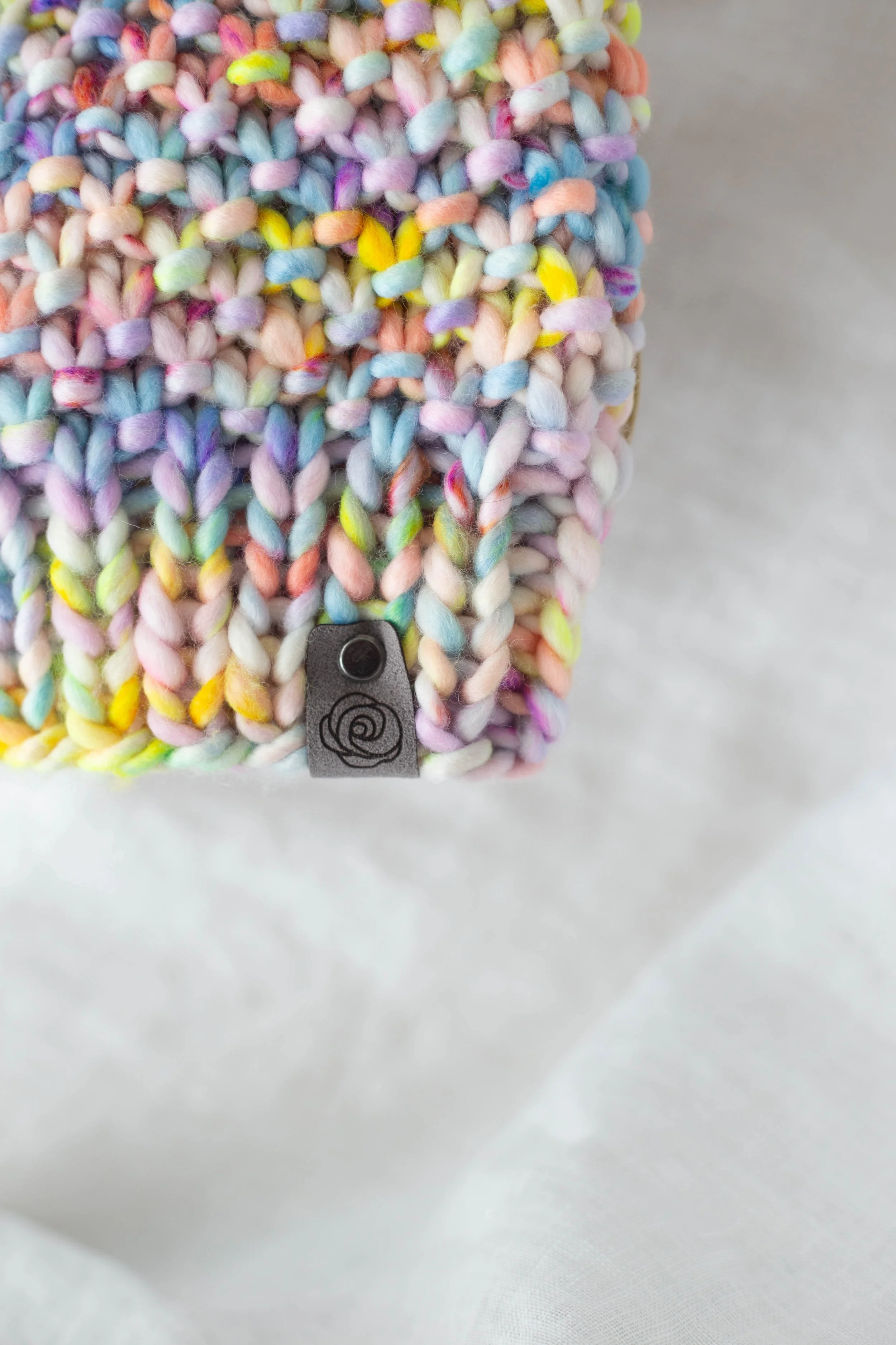 Close up of twisted stitch hat and pom