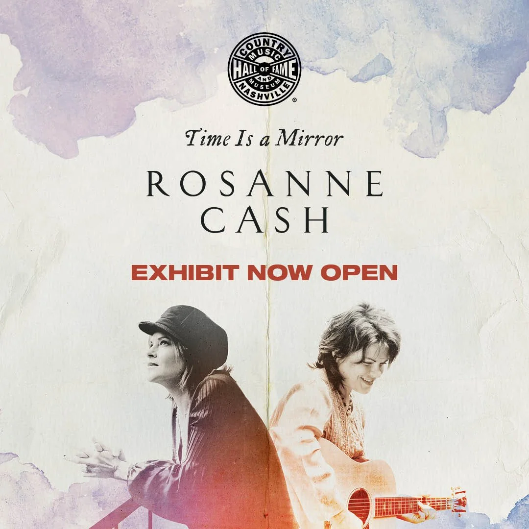Poster advertising the exhibit of Rosanne Cash titled 'Time Is a Mirror' at the Country Music Hall of Fame and Museum, Nashville, with images of Rosanne Cash holding a guitar and sitting, and text in black, red, and purple watercolor background.