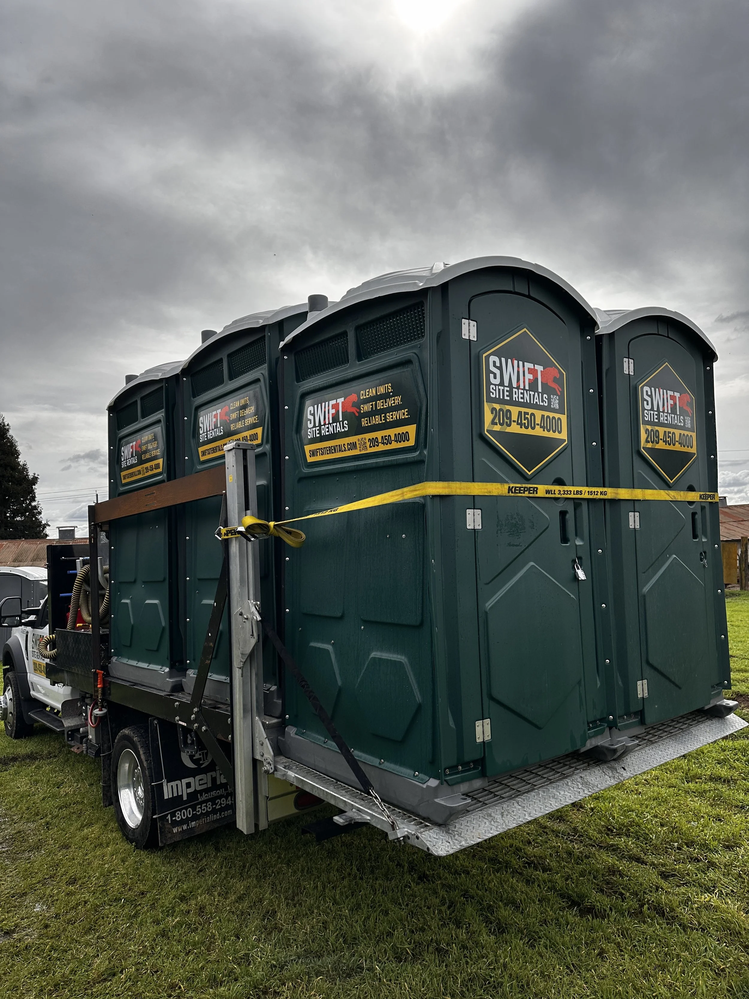 SWIFT Site Rentals pump truck carrying portable toilets in Oakdale, California