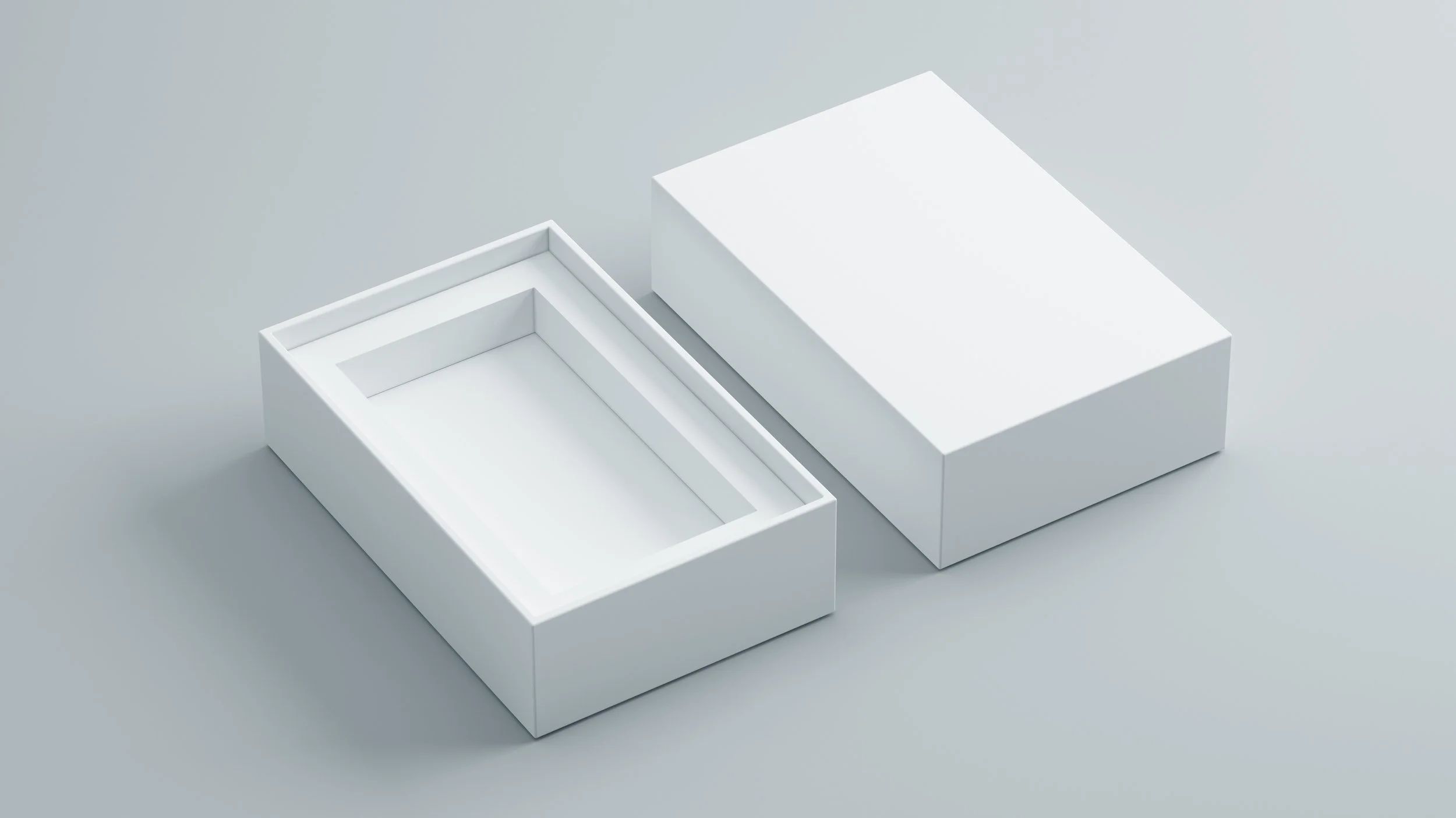 Opened white box with removable lid placed next to it on a light gray surface.