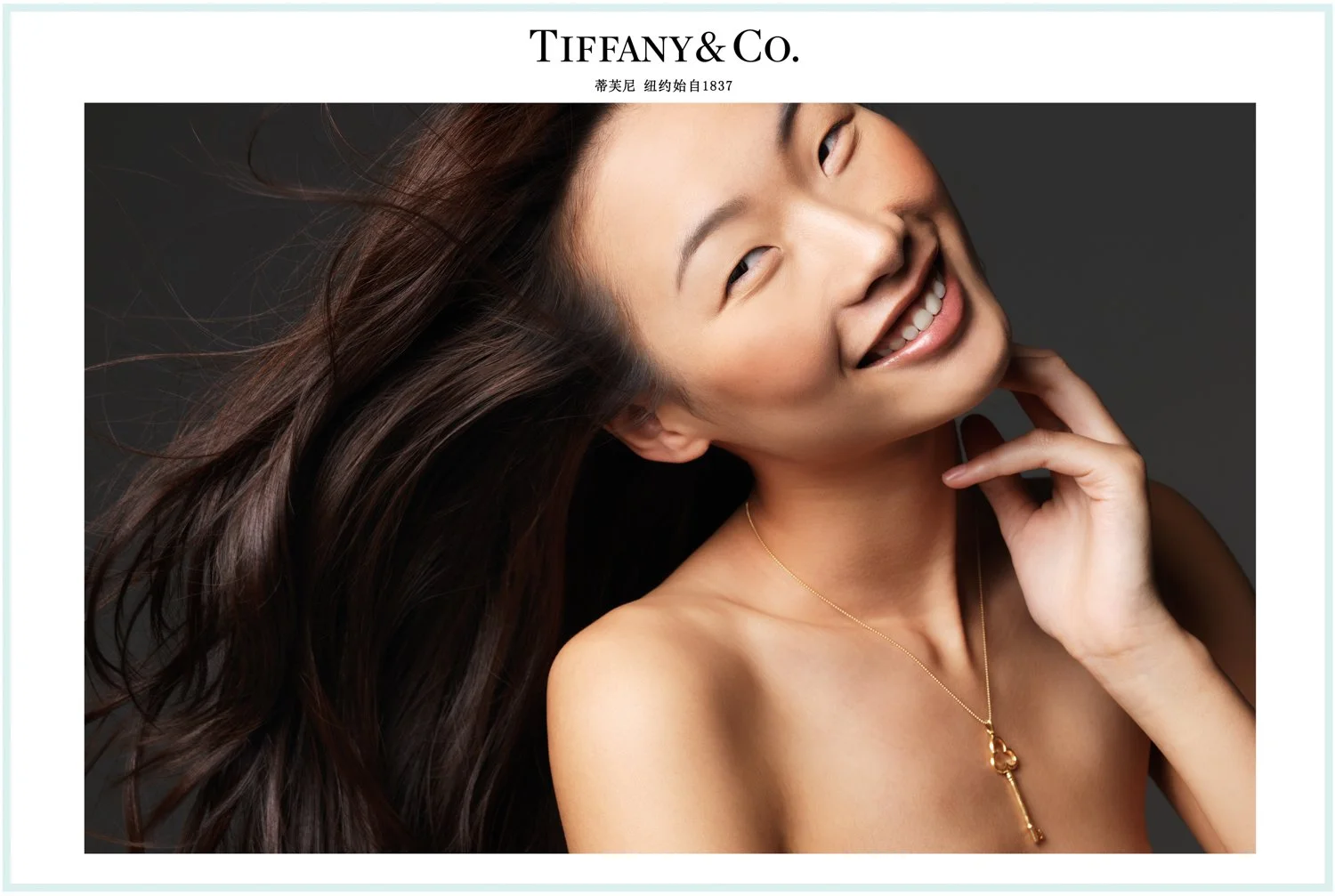 Beauty portrait of model with natural skin and red lip, wearing diamond jewelry, Tiffany&Co. campaign photographed by Stockton Johnson