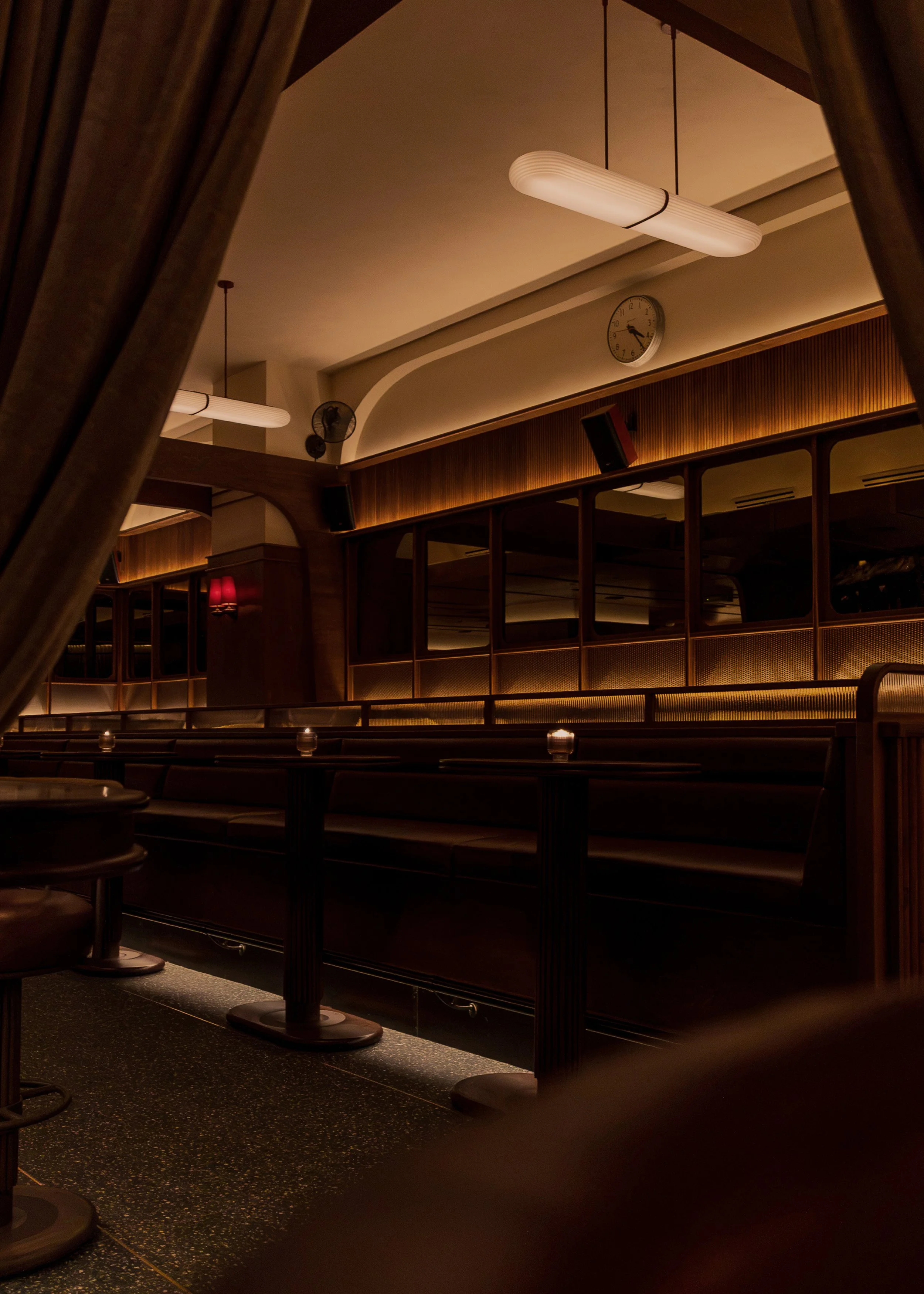 Leather banquette seating and individual viewing screens create an intimate setting for watching sports over dinner and drinks.
