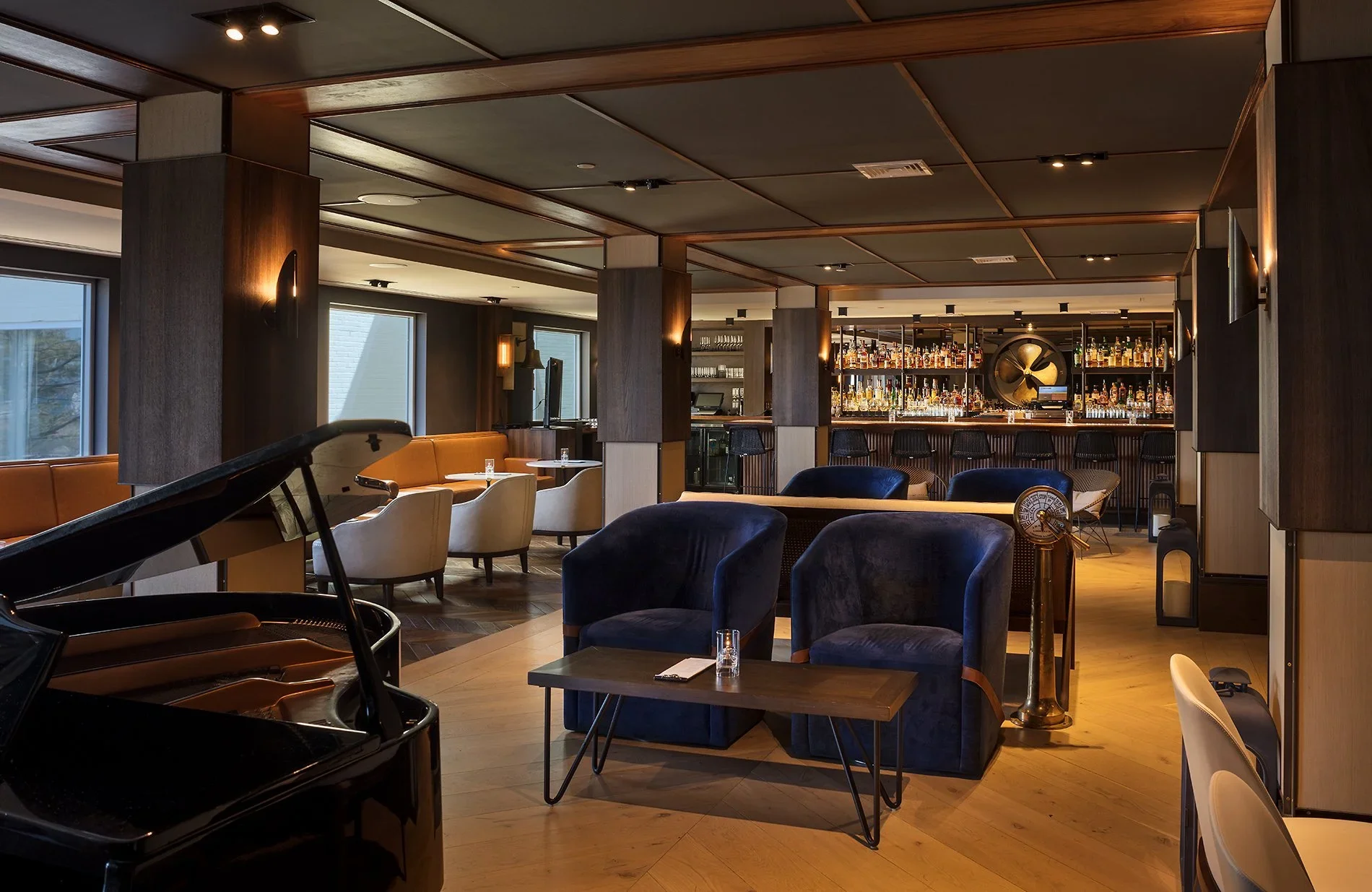 Regency Lounge at Gurney’s Newport Resort & Marina with masculine design, classical detailing and expansive water views.