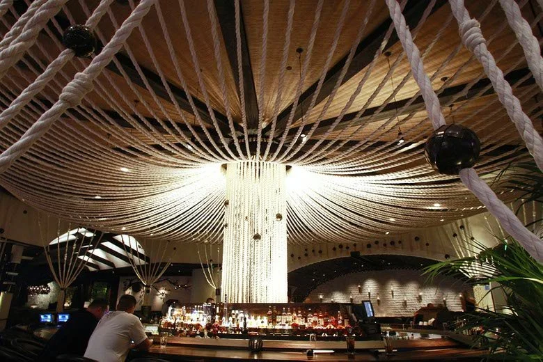 Mexican Restaurant’s Design Includes a Rope Canopy and Chainsaw Wood Mural