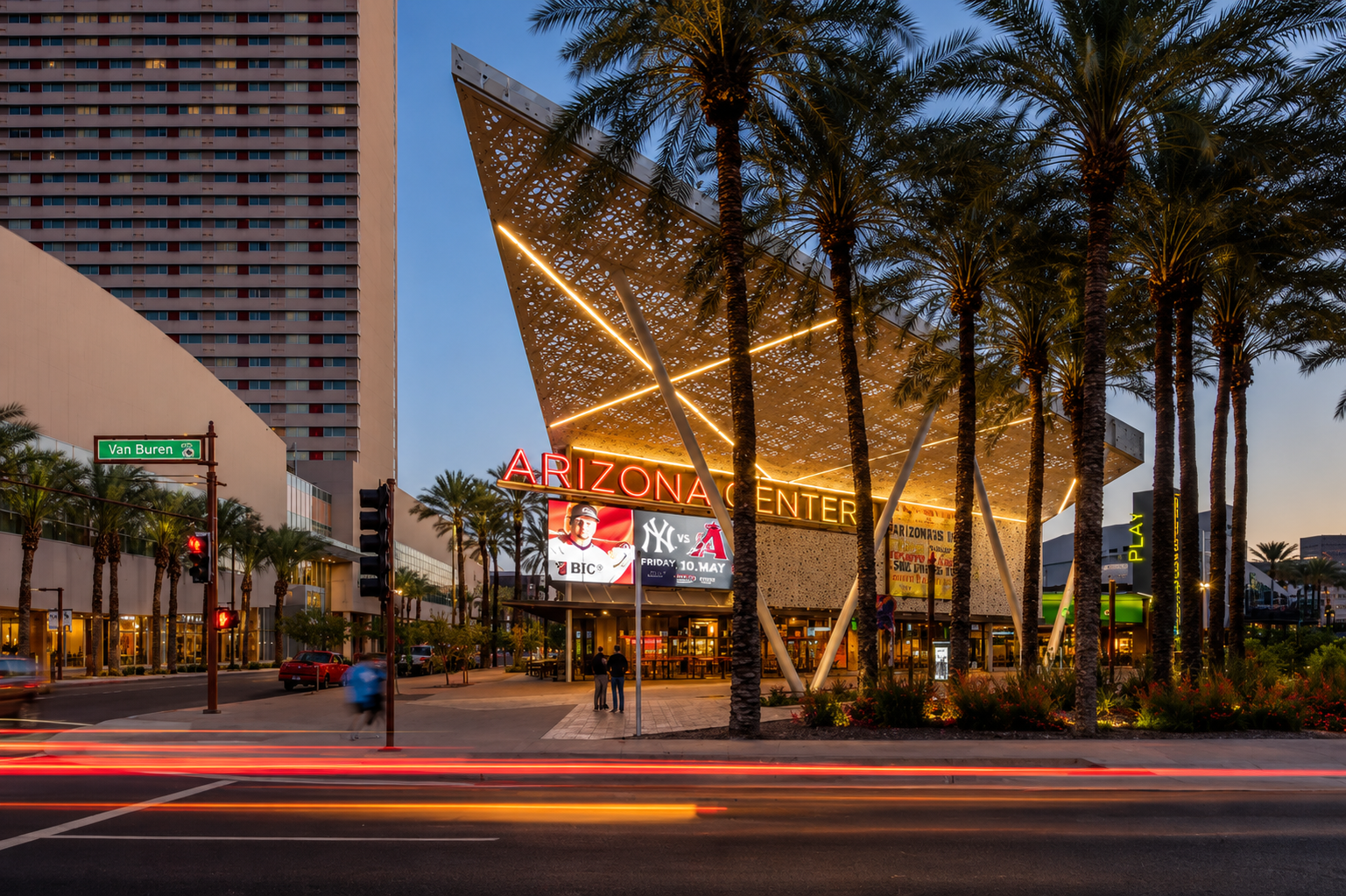 Arizona Center in Downtown Phoenix, viewed from the street with palm trees, illuminated architectural canopies, and the Arizona Center sign.