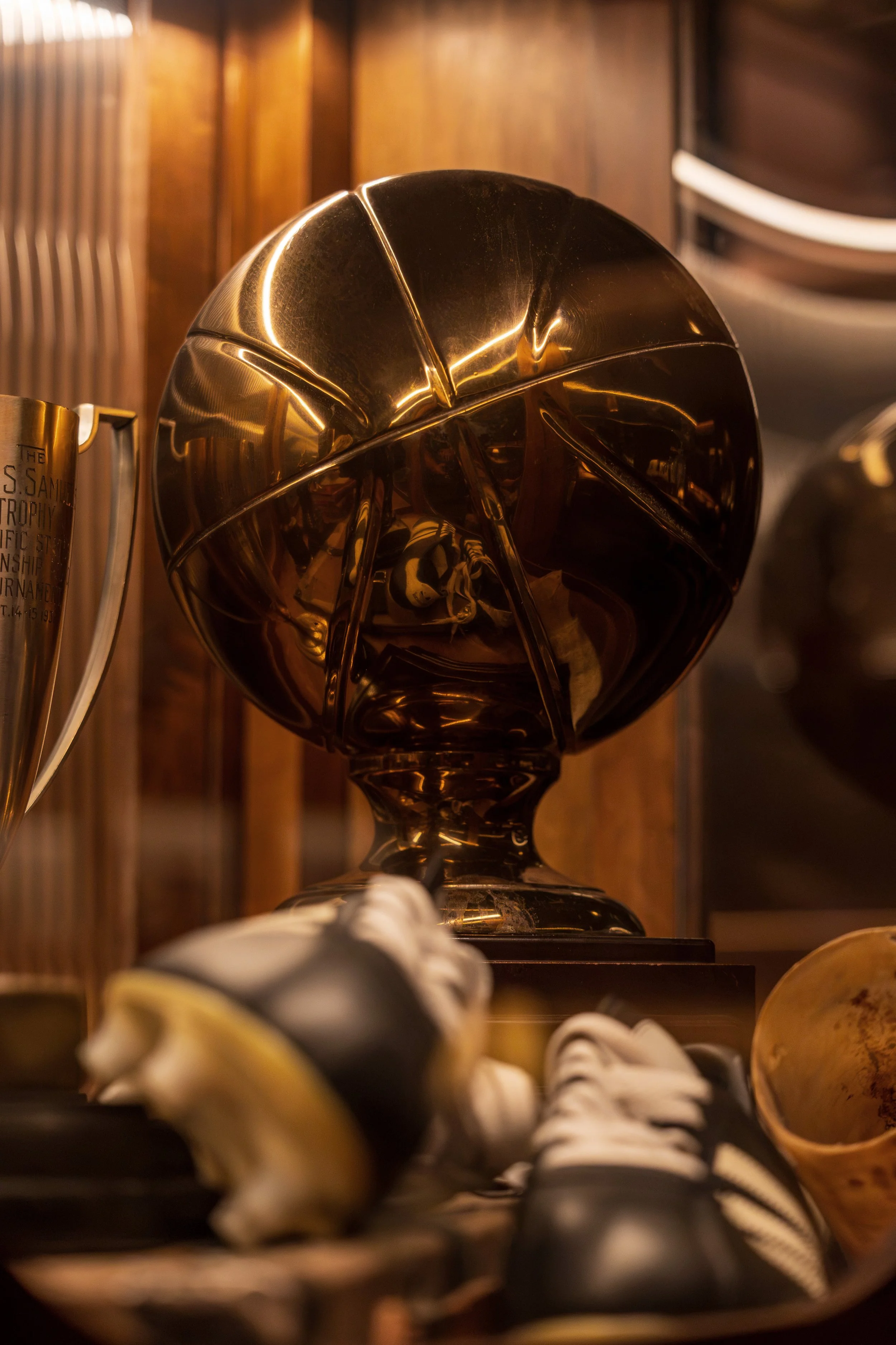 Close-up of a sculptural sports trophy displayed among Austin Sports Club’s collection of vintage athletic memorabilia.