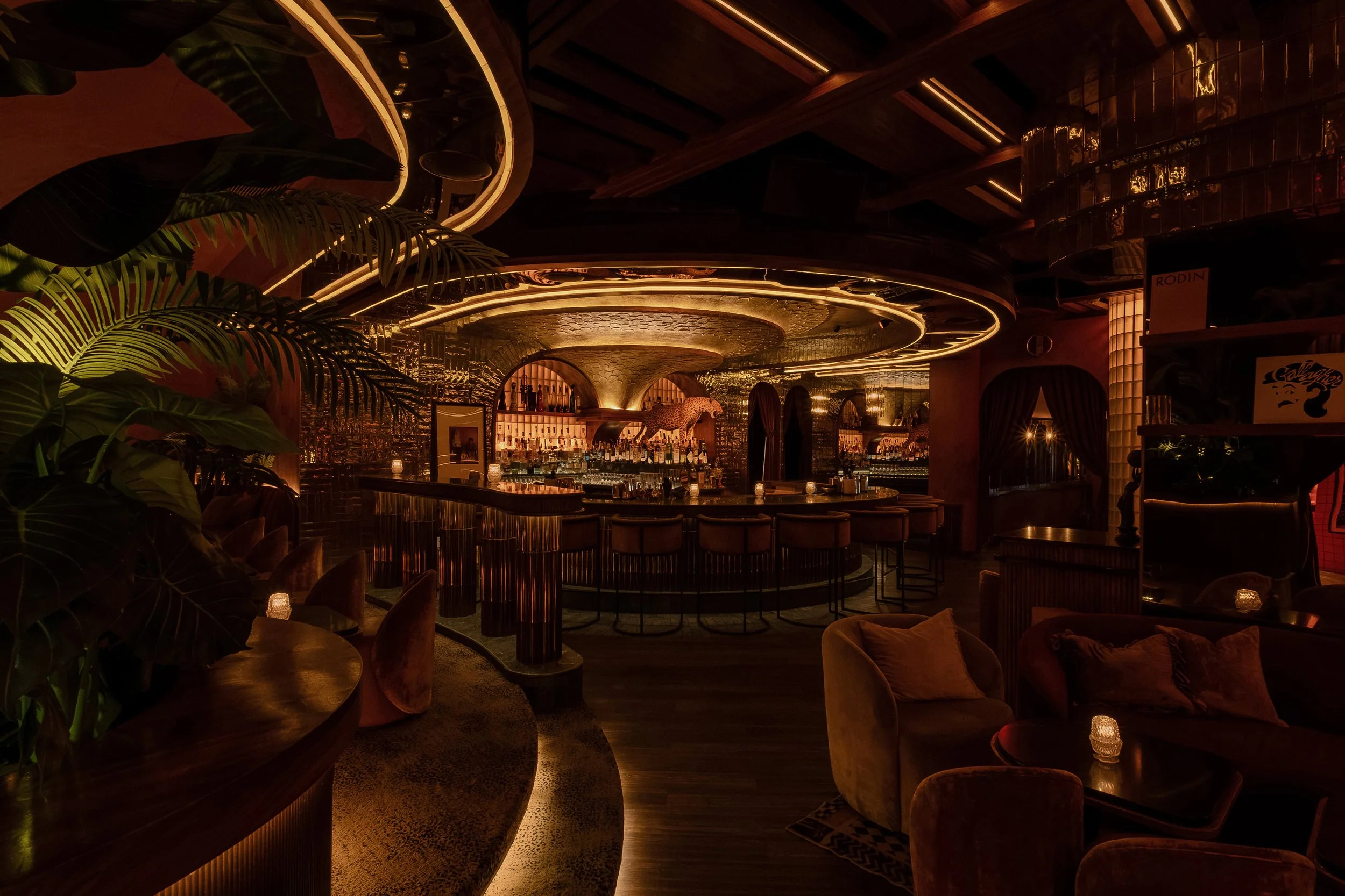 Curved steps lead into Powder Room’s richly layered cocktail lounge and circular central bar.