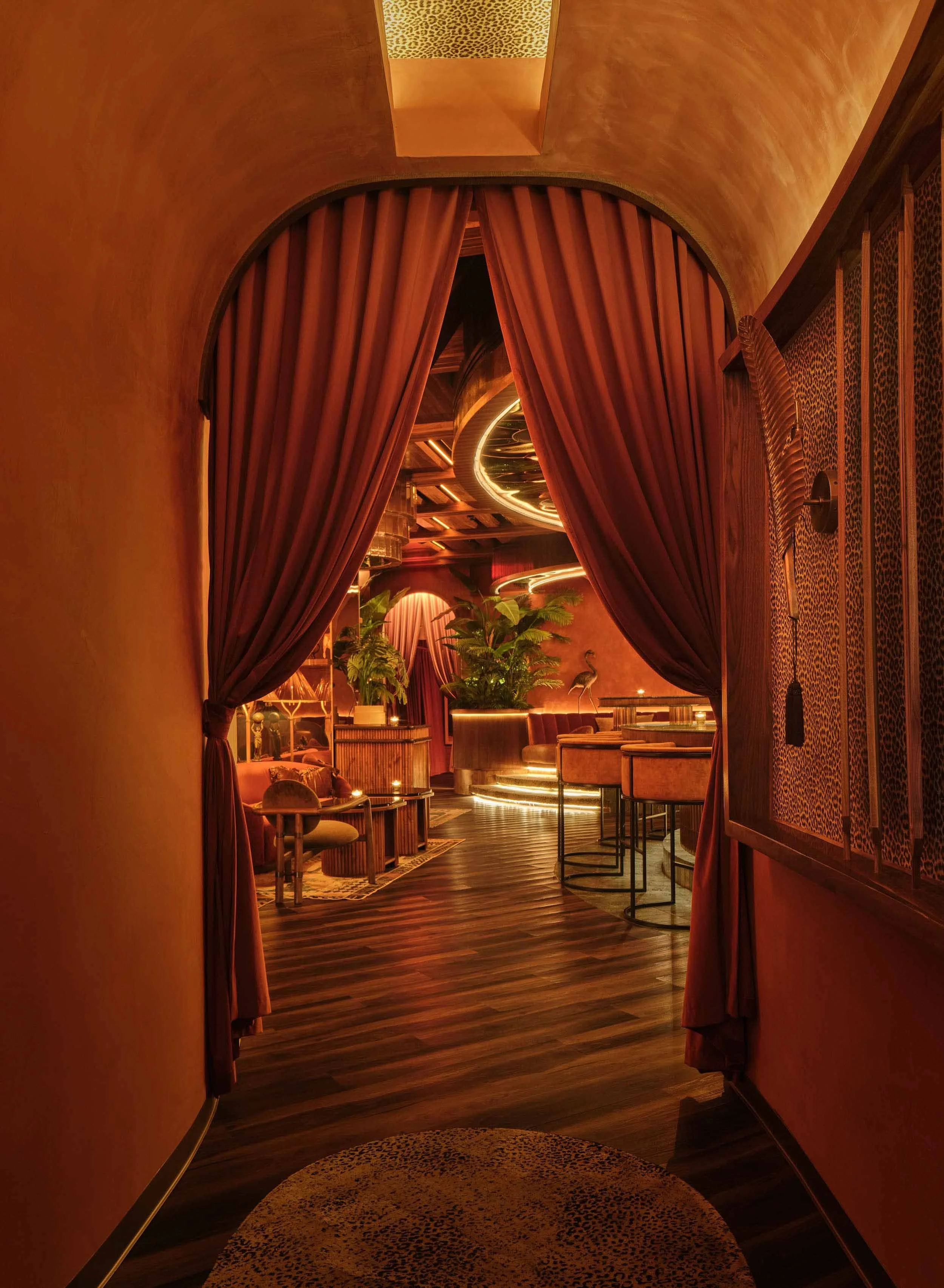 Velvet curtain entry to Powder Room speakeasy in Austin, designed by Peter Maxwell Bowden of PETERMAX Co.