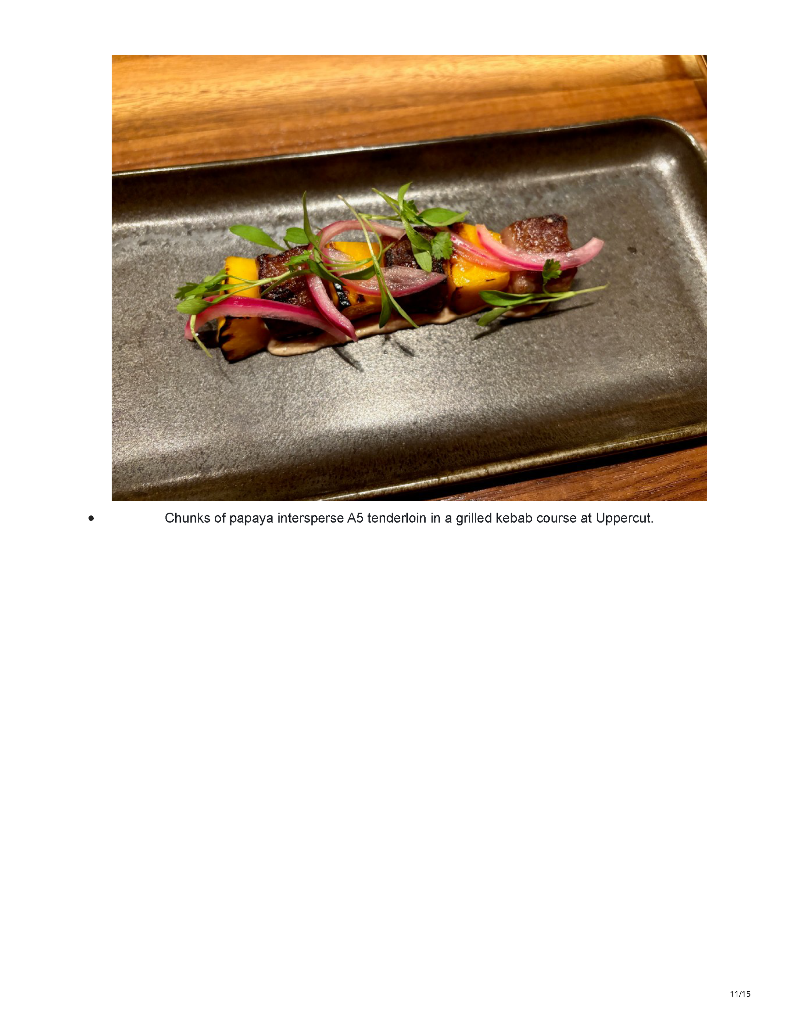 Grilled A5 tenderloin and papaya kebab course with pickled onion and herbs at Uppercut.