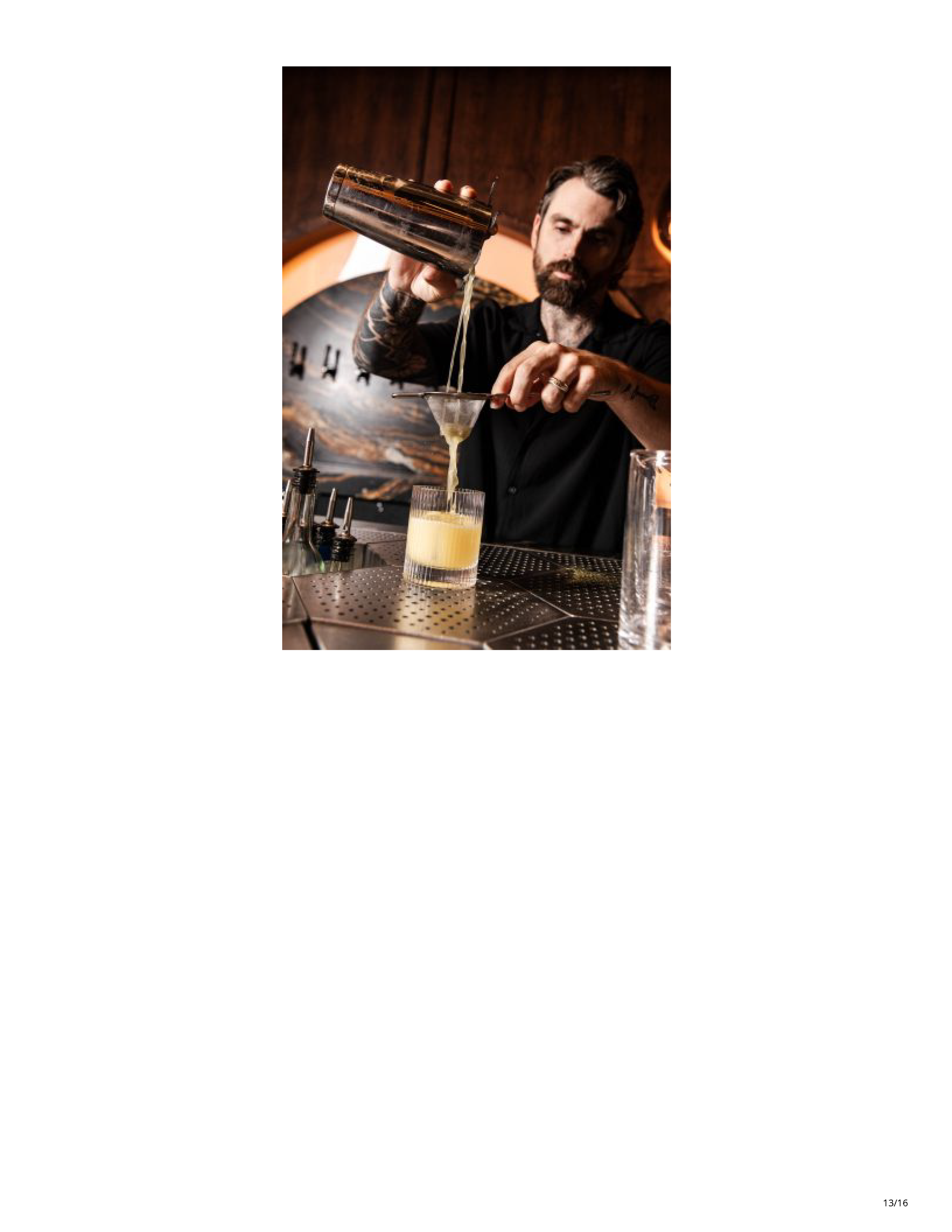 Jax Donahue straining a cocktail behind the bar at Drop Dead Gorgeous.