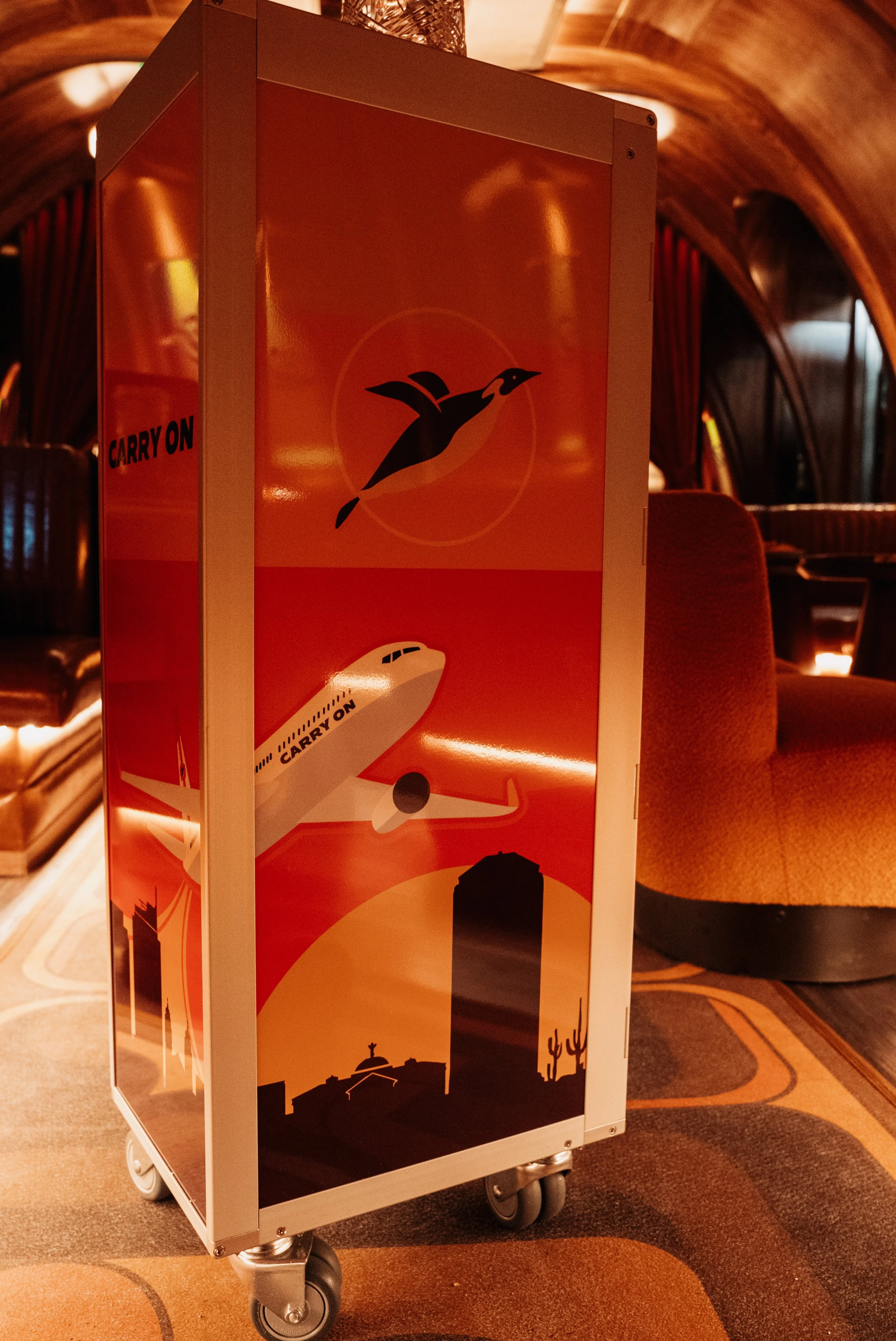 A custom-designed airline beverage cart with the Carry On Airlines logo
