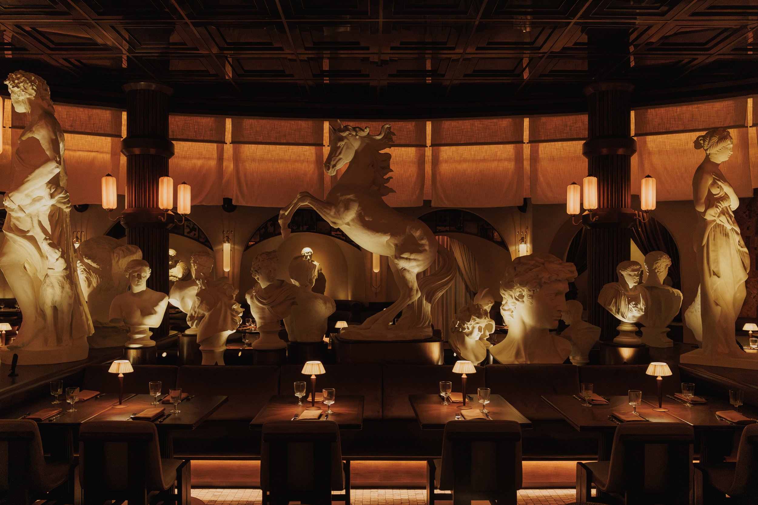 Panoramic sculptural installation of horses, busts and classical figures above the central dining area at Roman God of Fire in Tempe.